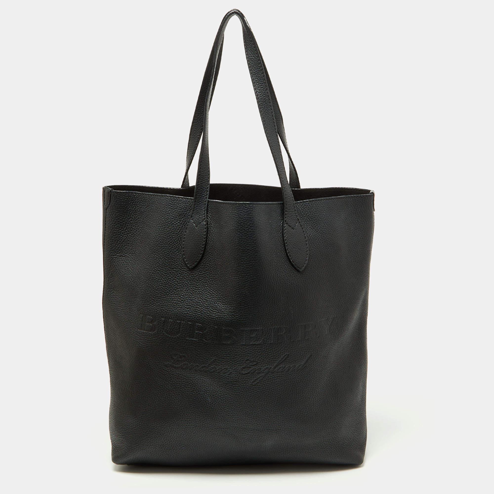 Spacious, durable, stylish — Burberry's Remington shopper tote is a fine example of what an everyday bag should be. This designer tote is crafted using black leather and added with two flat handles, a spacious interior, and front logo detail.

