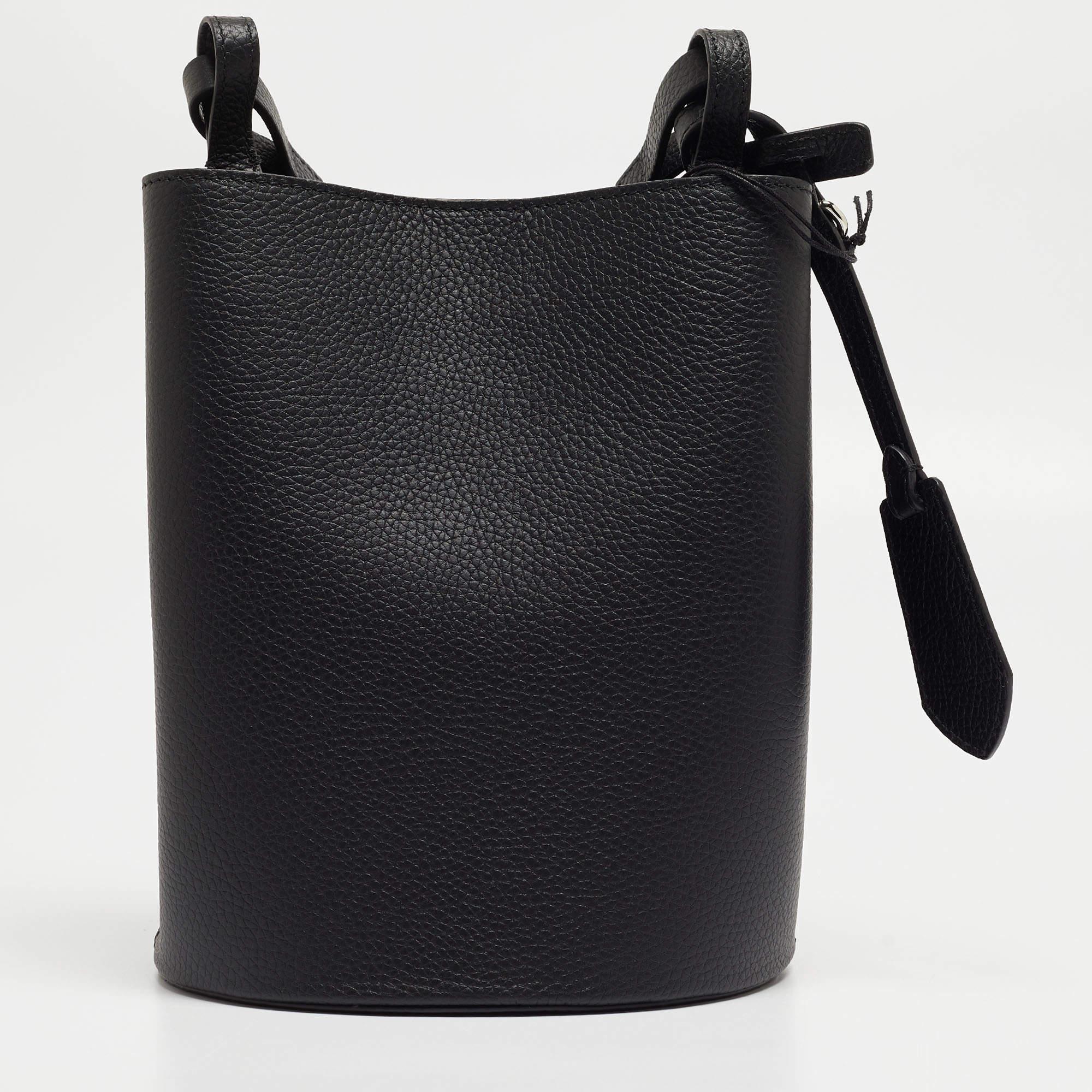 Get style and carry your essentials with ease using this bucket bag by Burberry. It has been crafted from leather and enhanced with silver-tone hardware. A slim strap and front logo complete it.

Includes: Original Dustbag, Info Booklet, Brand Tag

