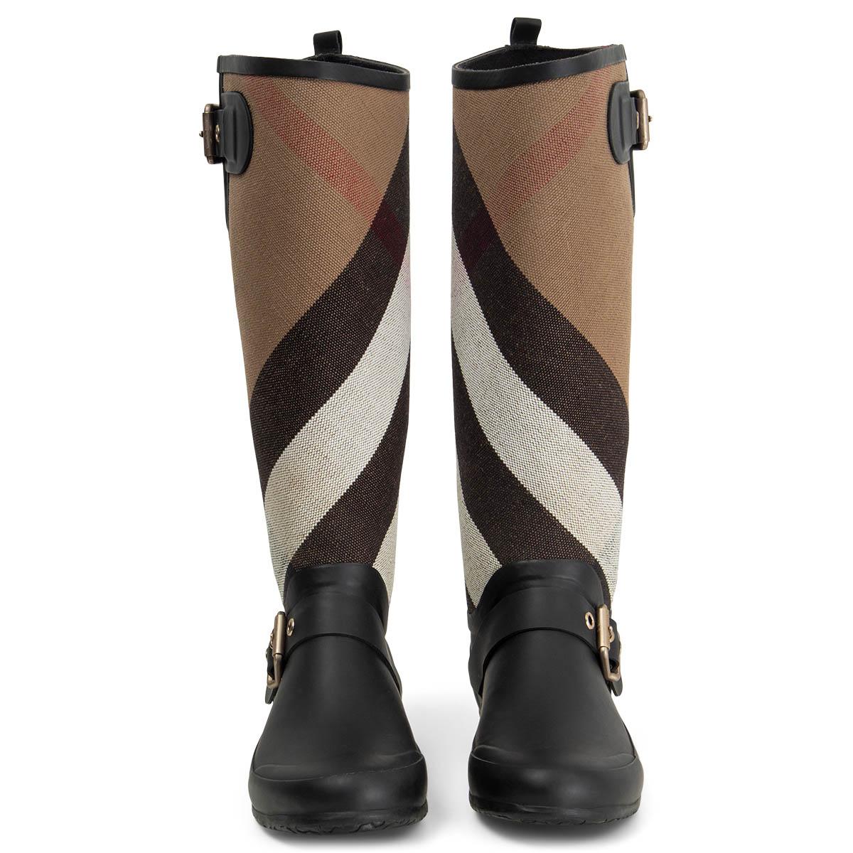100% authentic Burberry rain boots in black rubber a and camel, white, red and black calssic plaid canvas featuring buckle details on the side and top. Have been worn and are in excellent condition. 

Measurements
Imprinted Size	35
Shoe