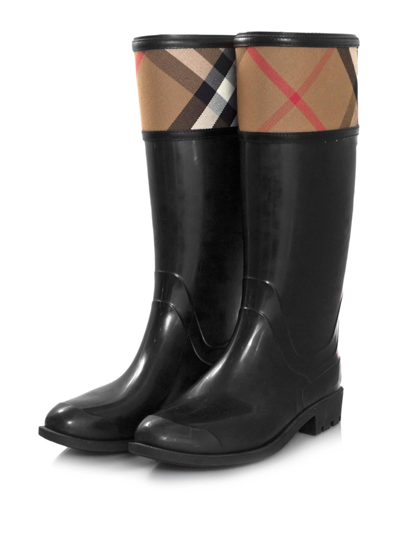 Burberry Black Rubber Crosshill Housecheck Rain Boots Sz 39

Made In: Italy
Color: Black, beige
Materials: Canvas and rubber
Closure/Opening: Slide on
Sole Stamp: Burberry Made in Italy 39
Retail Price: $350 + tax
Overall Condition: Excellent