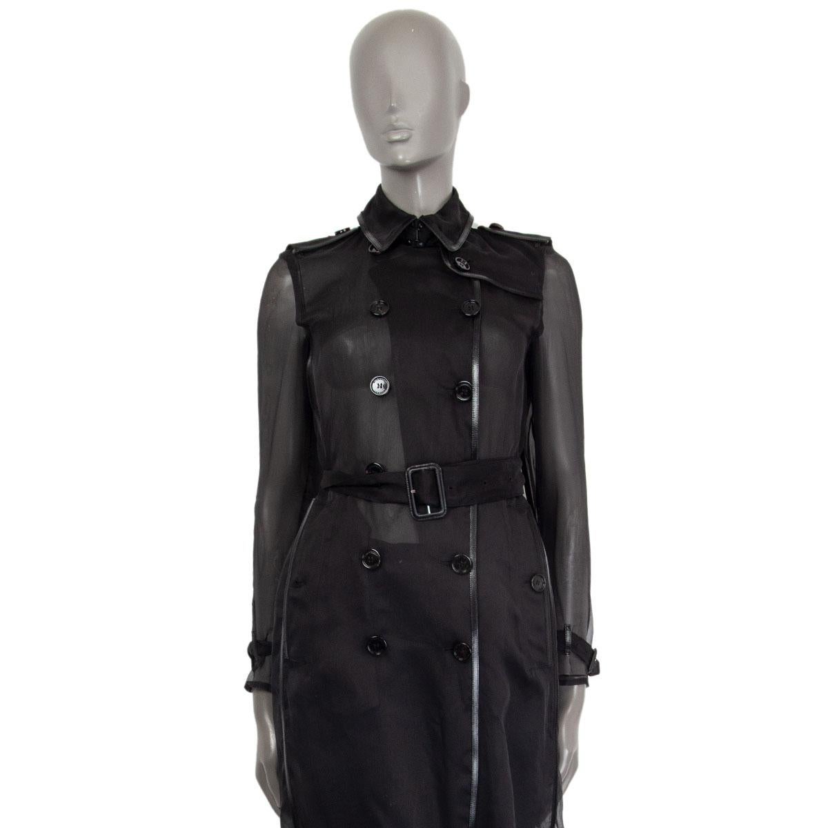 Burberry organza trench coat in silk (100%) with a flat collar, apaulettes, buttoned slit pockets and belted cuffs. Has calf leather trimming details. Closes on the front with buttons. Unlined and sheer. Has been worn and is in excellent