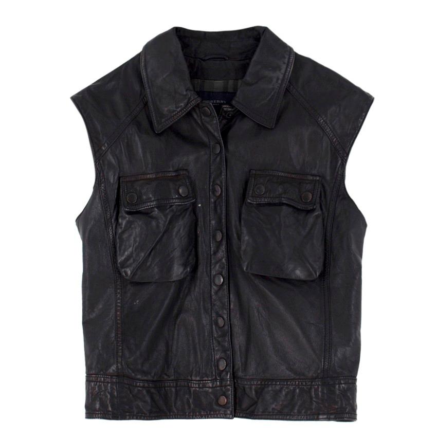 Burberry black sleeveless leather gilet

- Black leather sleeveless jacket
- Press stud fastening
- Bust press stud pockets
- Checked lining

Please note, these items are pre-owned and may show some signs of storage, even when unworn and unused.