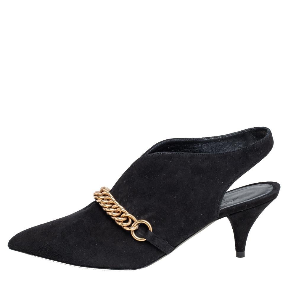 A feminine flair, sleek cuts, and a timeless appeal characterize these stunning Burberry pumps. Skillfully crafted from black suede, they are designed into a pointed-toe silhouette and adorned with chain links. The pumps are raised on low heels and
