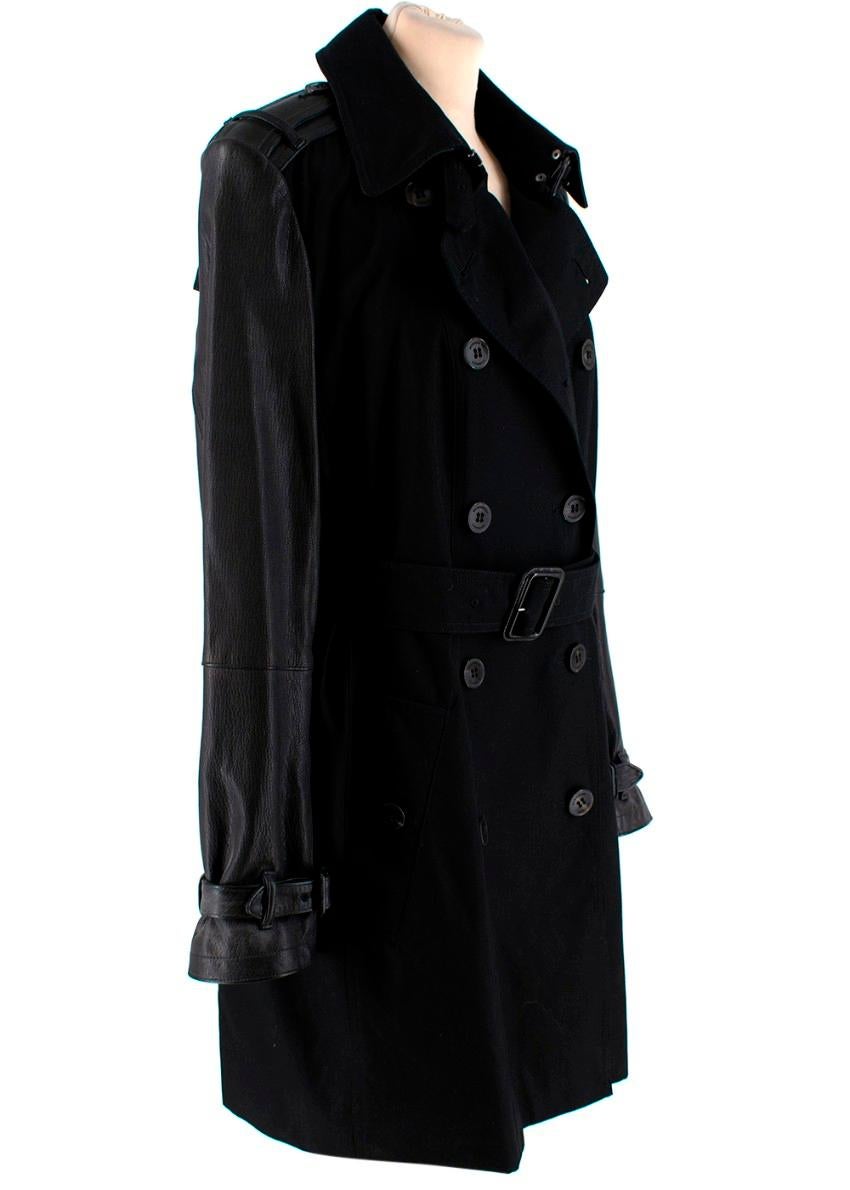 Burberry Black Trench Coat with Leather Detail

- Buckle and clasp neck fastening 
- Button fastenings through double-breasted front
- Slightly loose fit, use the belt to cinch in at the waist
- Detachable belt
- Leather sleeves 
- Zip fastening on