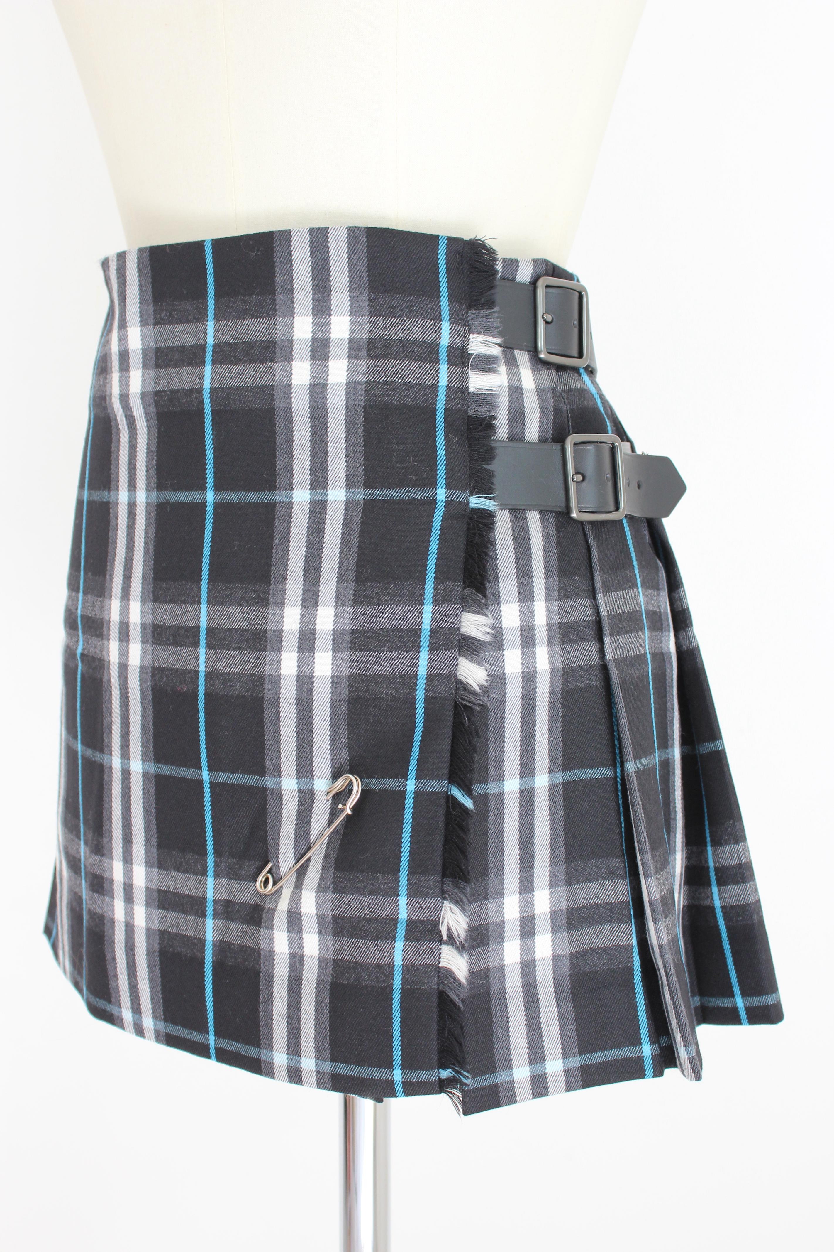 Burberry 2000s skirt. Wrap skirt, knee length, tartan kilt model with checked pattern. Black and white color. Internal velcro closure and two belts. Pin applied. 100% wool fabric. Made in Scotland.

Condition: Excellent

Article used few times, it