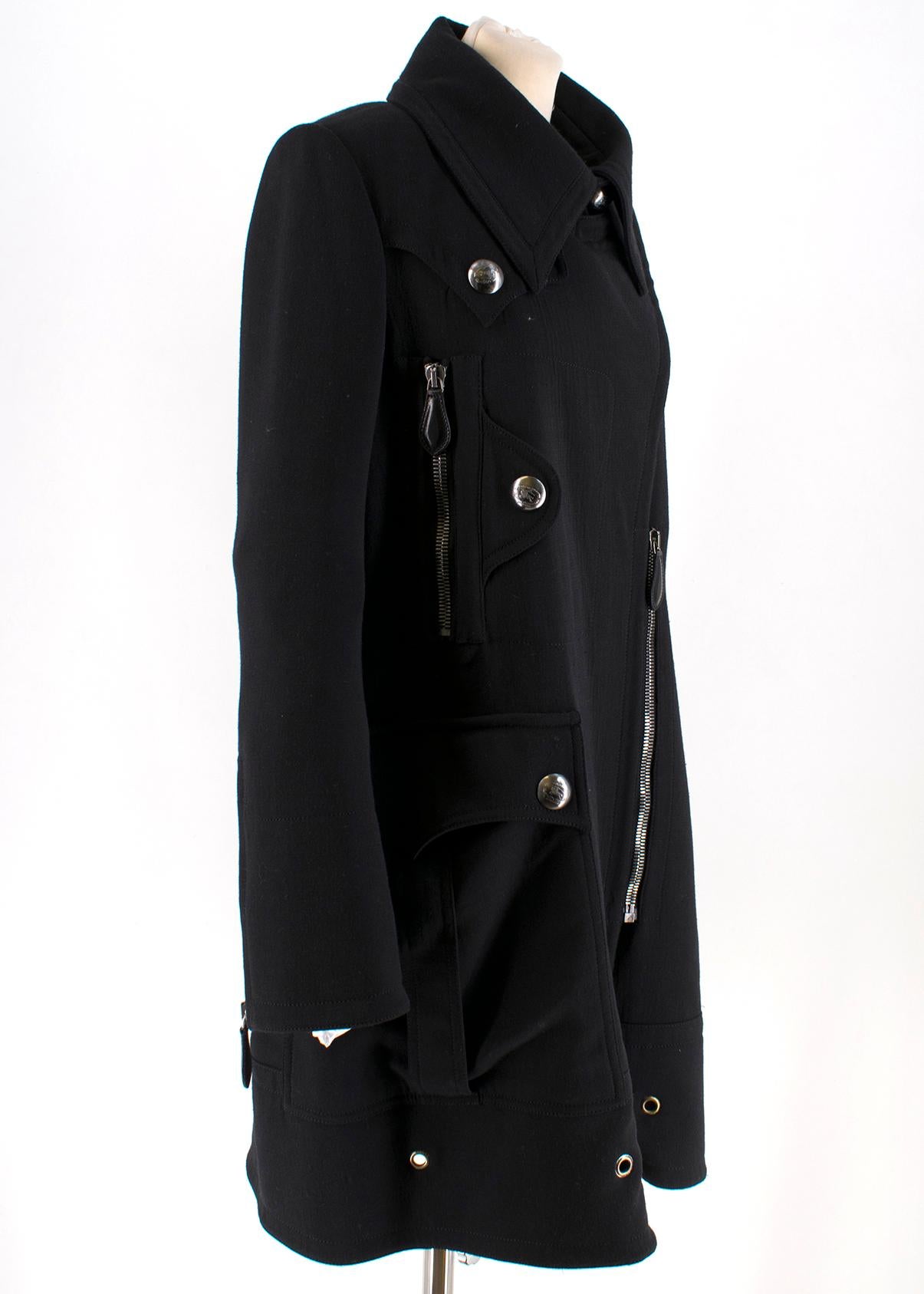 Burberry Black Wool Coat  
 
- Wool black coat 
- Black satin lining
- Two front button pockets
- Two front chest zip pockets 
- Embellished with large Burberry buttons

Please note, these items are pre-owned and may show some signs of storage, even