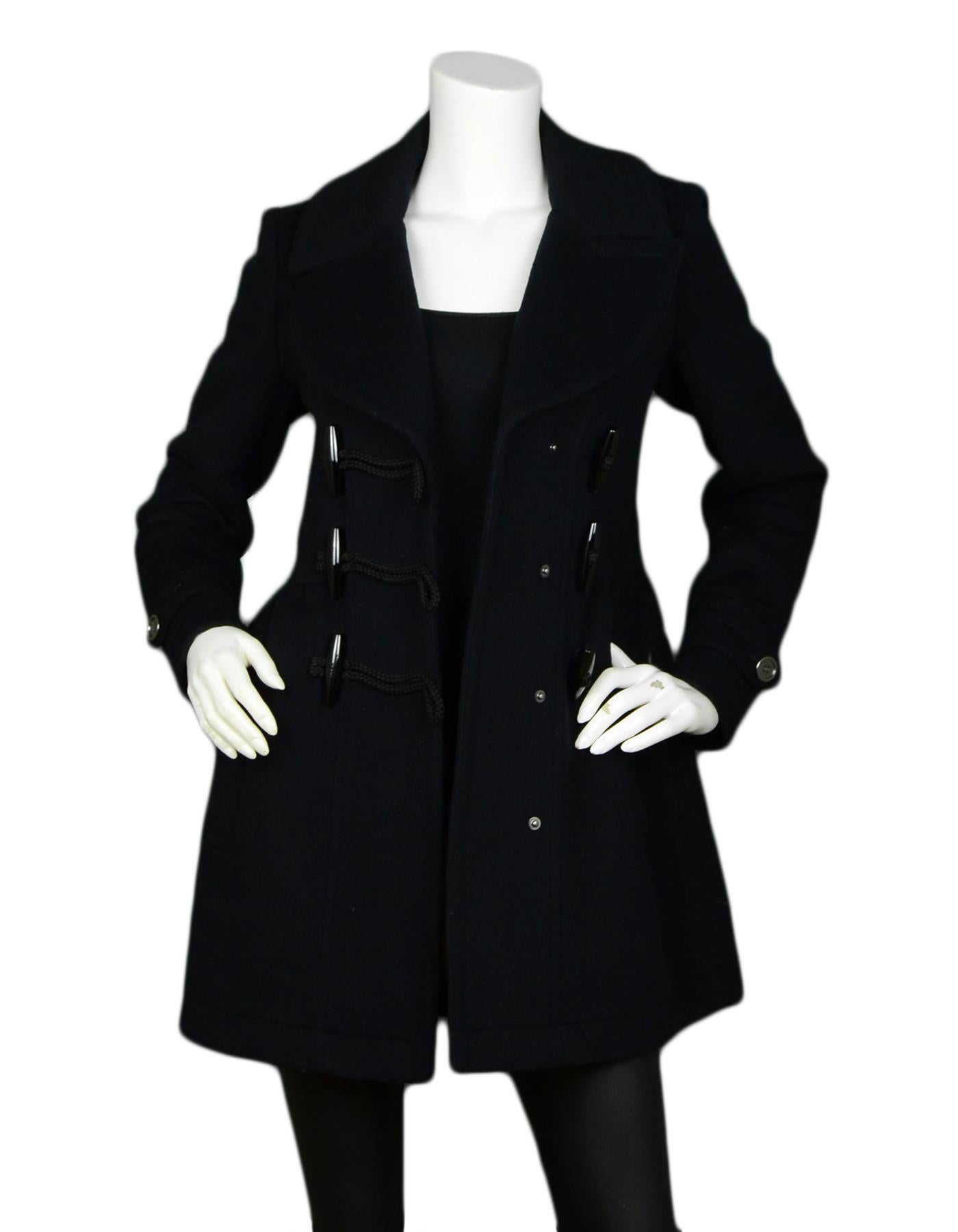 Burberry Black Wool Coat w/ Toggle sz 4

Made In: Romania 
Color: Black
Materials: 100% Wool
Lining: 100% Wool
Opening/Closure: Excellent pre-owned condition
Overall Condition: Toggle Closure

Tag Size: 4 *Please refer to measurements to ensure