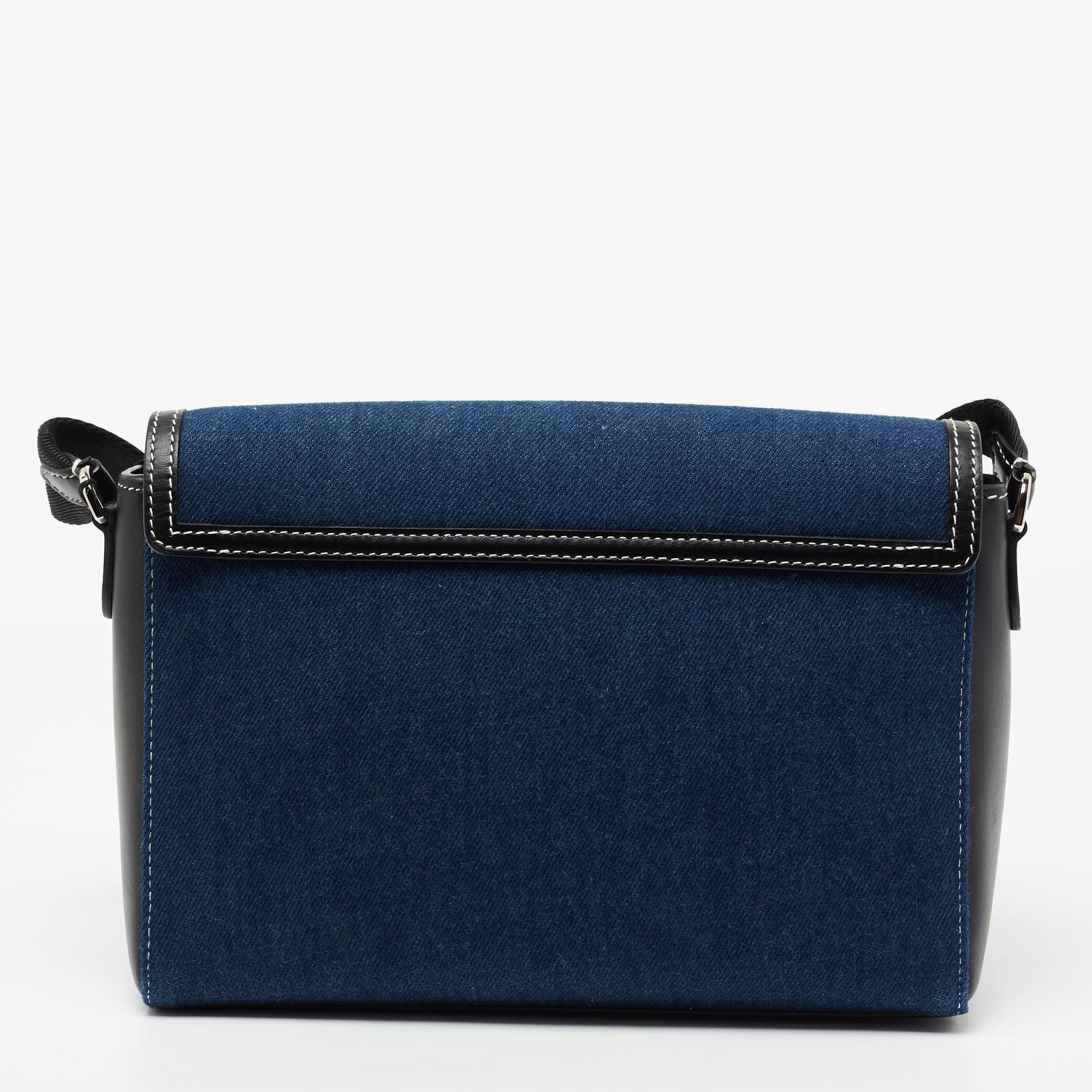 Basic essentials can be carried effortlessly in this blue-black crossbody bag from Burberry. Crafted from denim and leather, it features a graphic logo print on the front and a flap that opens into a well-sized interior.

Includes: Brand Tag