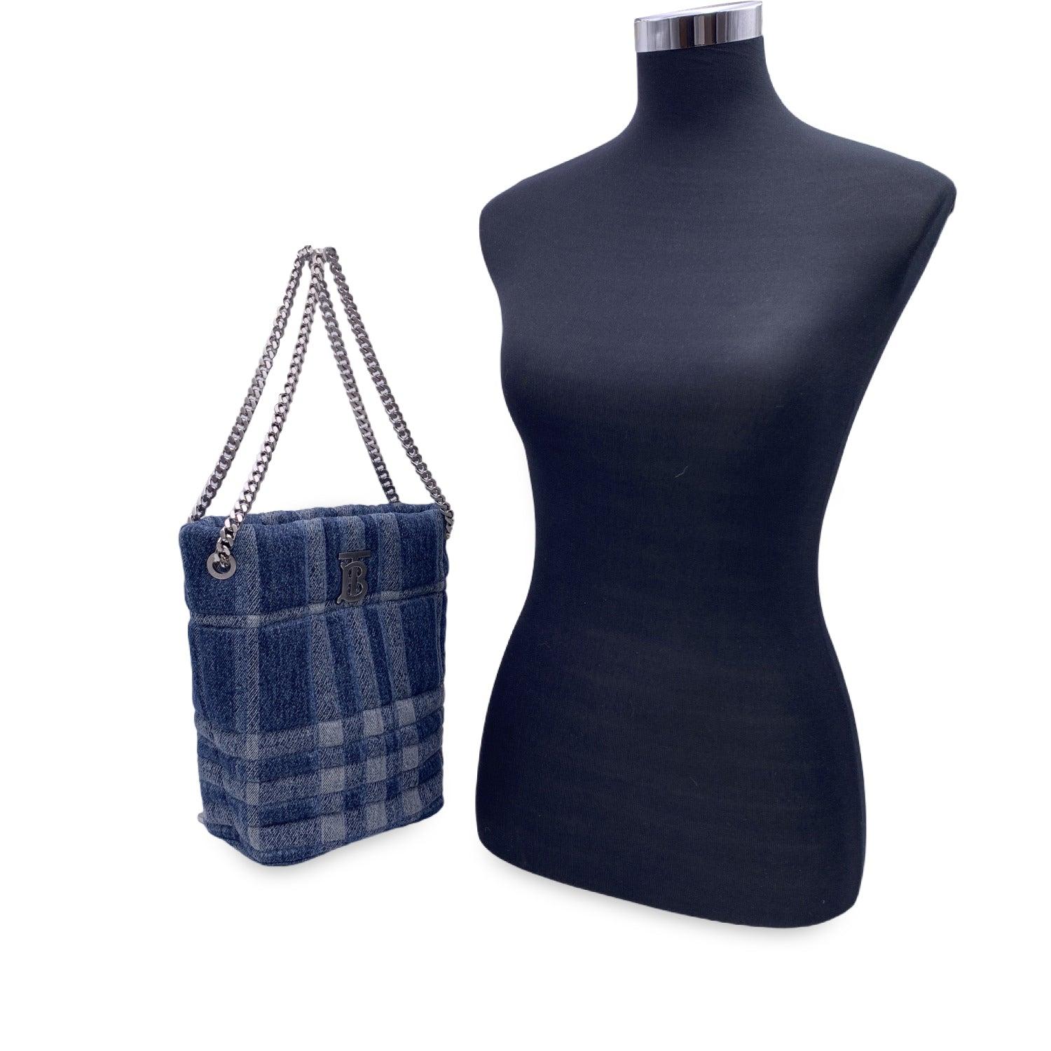 This beautiful Bag will come with a Certificate of Authenticity provided by Entrupy. The certificate will be provided at no further cost Burberry 'Small Lola' Shoulder bucket bag. Blue quilted denim and silver metal hardware. Magnetic button closure