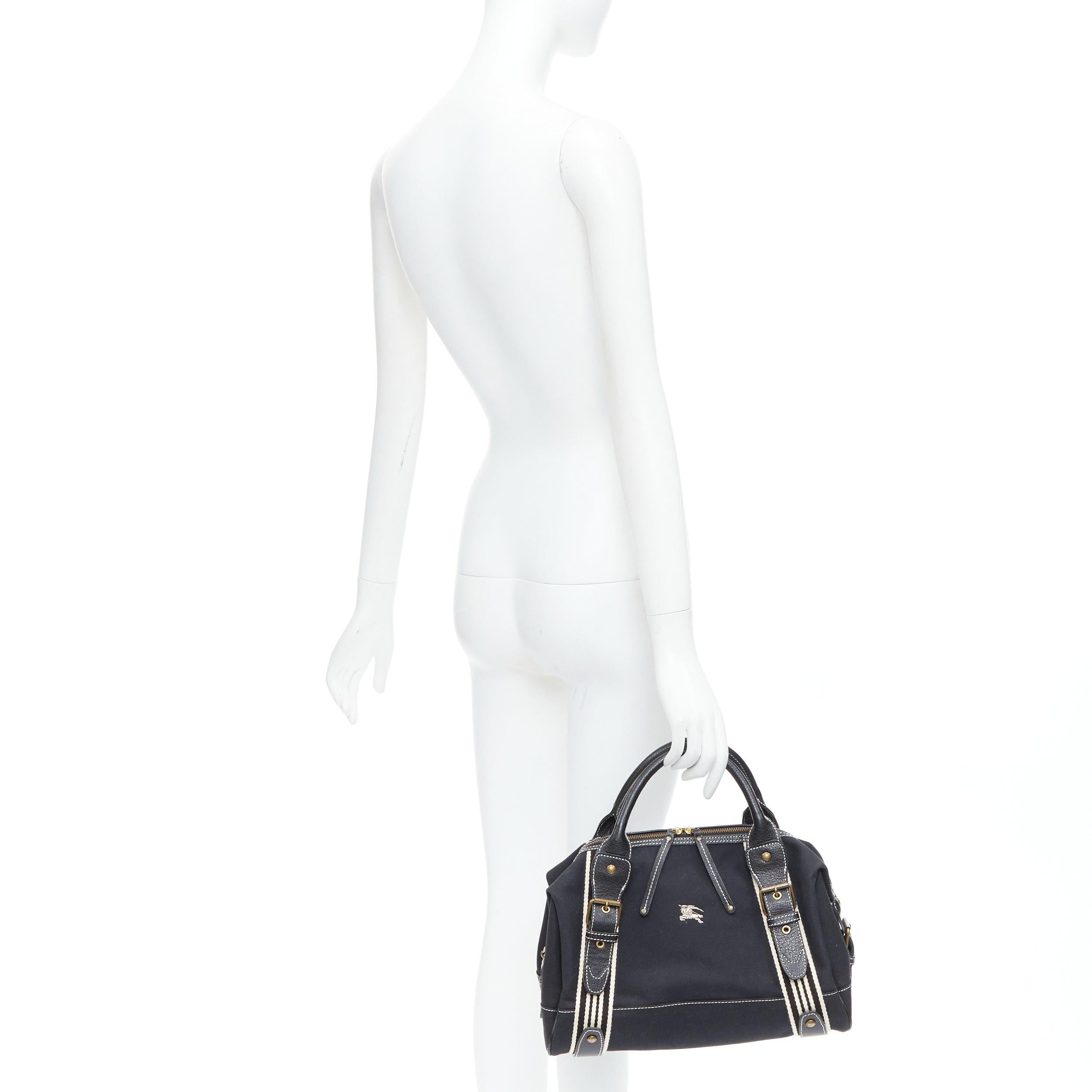 BURBERRY Blue Label black logo striped canvas satchel top handle bag
Reference: ANWU/A01341
Brand: Burberry
Collection: Blue Label
Material: Fabric, Leather
Color: Black, White
Pattern: Striped
Closure: Zip
Lining: Black Fabric
Made in: