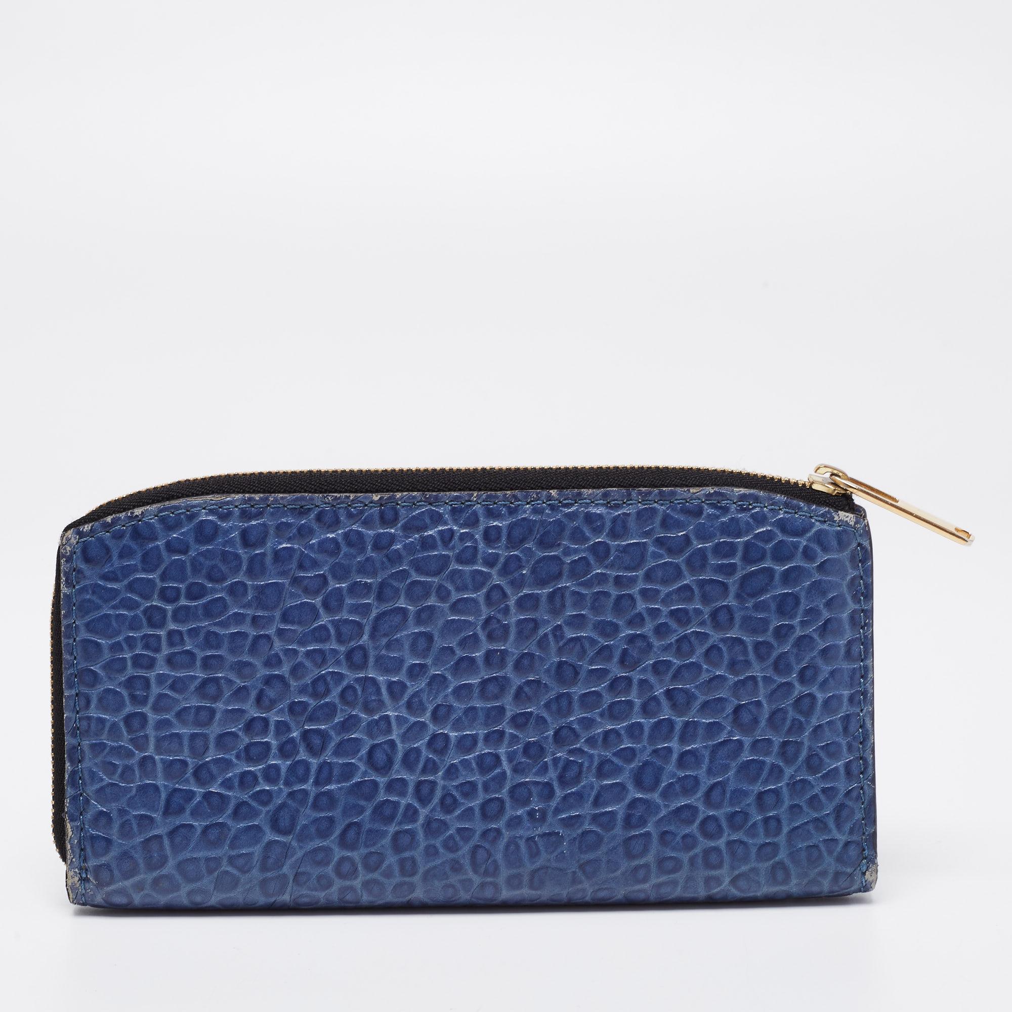 Made of blue leather, this continental wallet from Burberry is a classy choice. It has a zip pocket and multiple card slots. The wallet is complete with a brand-detailed accent on the front.

Includes: The Luxury Closet Packaging