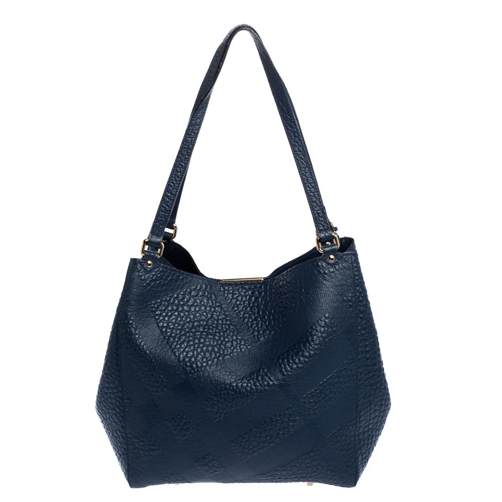 This Canterbury tote from Burberry is crafted from leather with its signature check design. It comes with dual flat leather handles, protective metal feet, and a leather-lined interior that can hold all your daily necessities. Simple in design, the