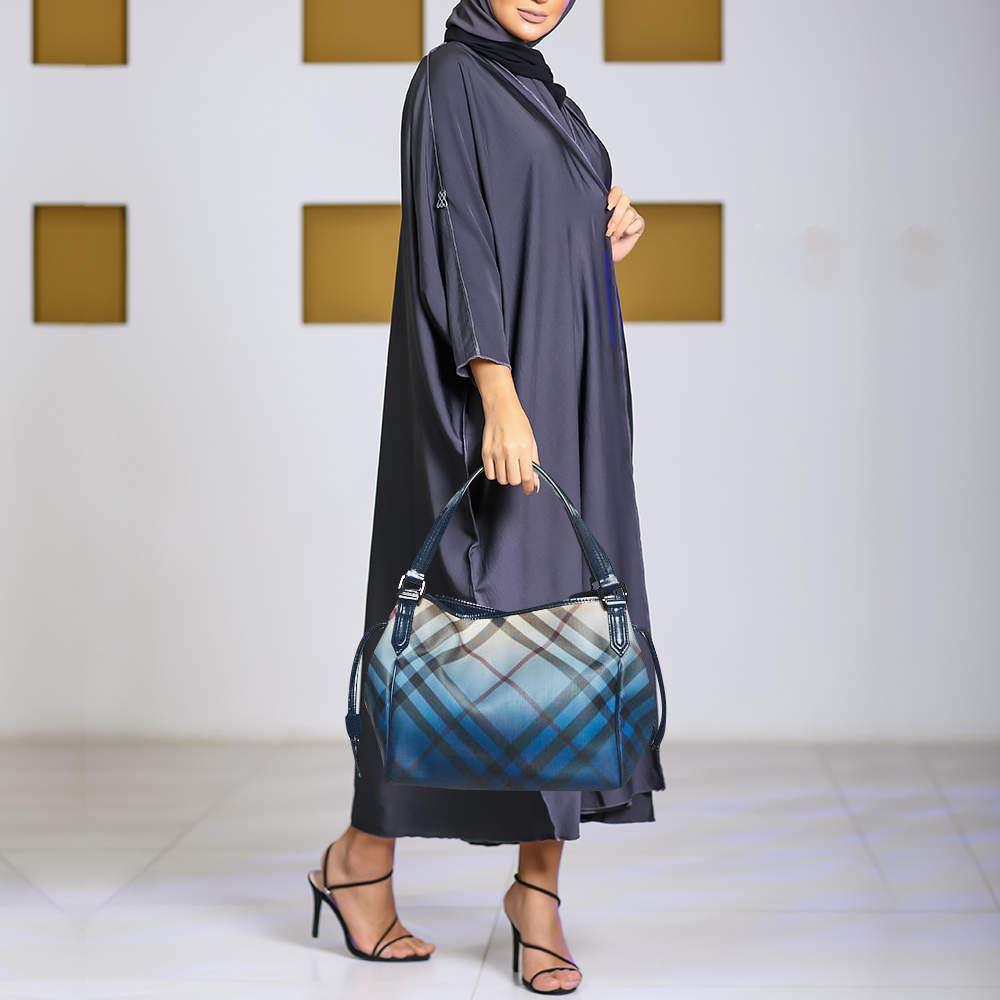 Supernova Check PVC in ombre blue fitted with leather handles and dark ruthenium hardware makes for a gorgeous handbag you'll love carrying to lunch, work, or shopping. The Burberry Bilmore tote is a preloved beauty you'll love having in your closet.