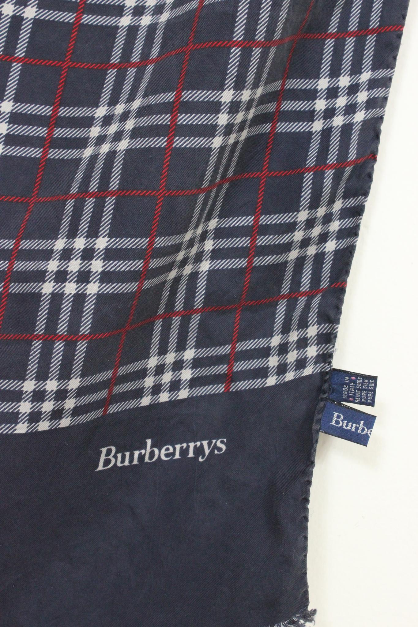 This vintage Burberry silk scarf features the classic blue, white and red check fantasy in an iconic 80s style. The luxurious fabric and timeless design are sure to make a statement!

Measures: 142 x 47 cm