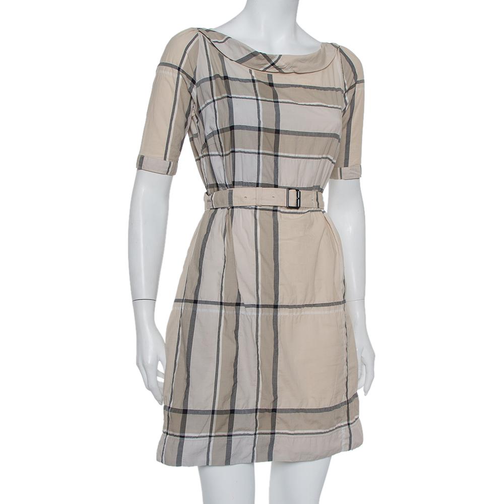Perfect to pair with both heels and flats, this Mischa dress from Burberry Brit is designed in a signature style with the highlight being the instantly-recognized check pattern all over. Fashioned with short sleeves, a back zipper, ad a belt, this