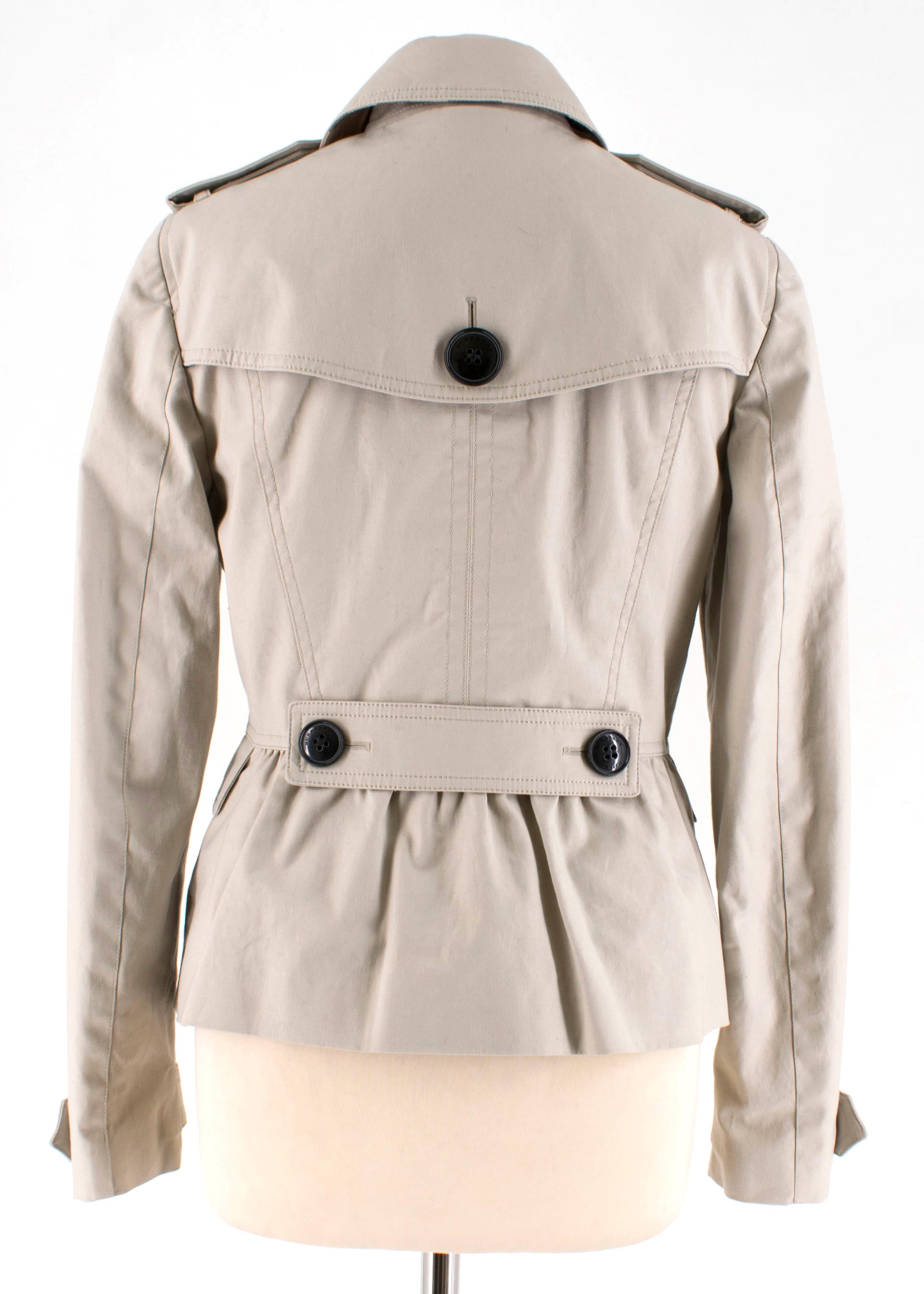 Burberry cropped trench coat in light beige with large buttons on front featuring an asymmetric silver-tone zip.

Measurements are taken with the item lying flat, seam to seam.
Sleeves:61cm
Length:60cm