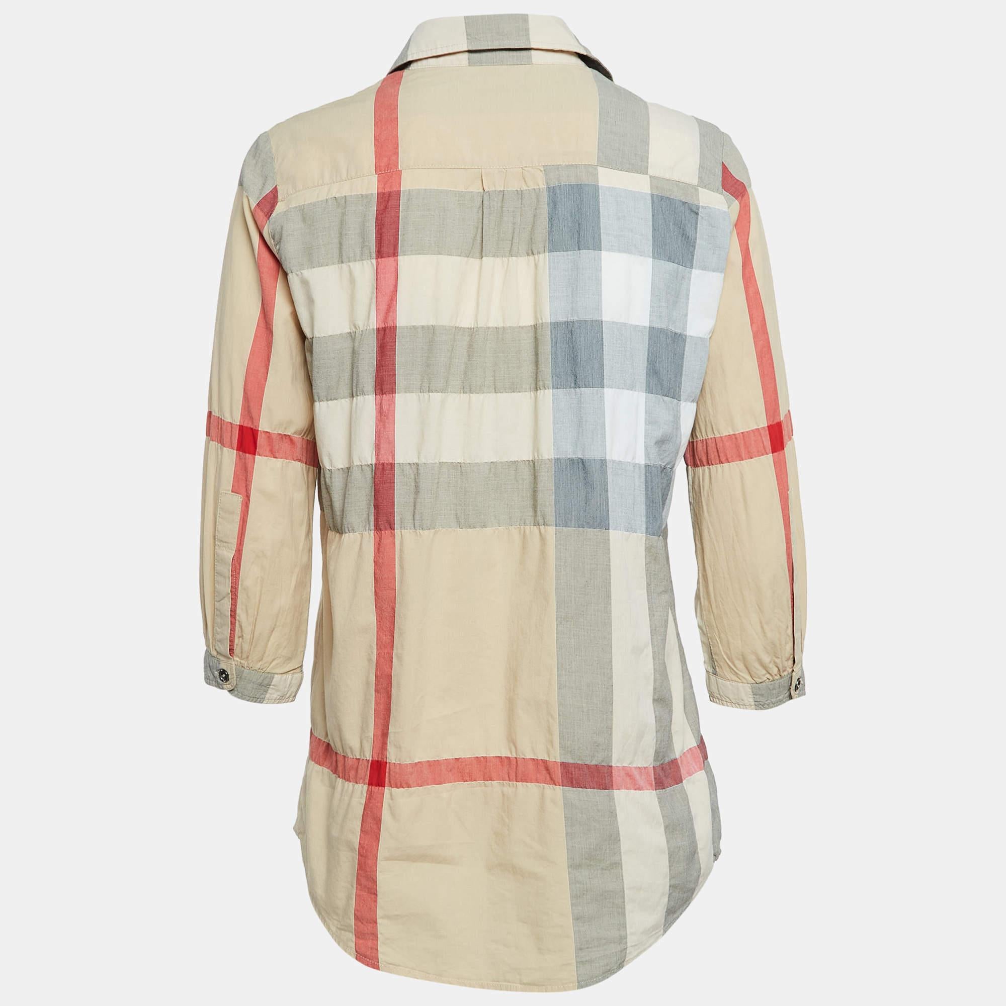 Turn heads when you wear this Burberry tunic that lends a sophisticated edge to your personality. It carries an impressive silhouette with front button closure and flaunts a beige shade.