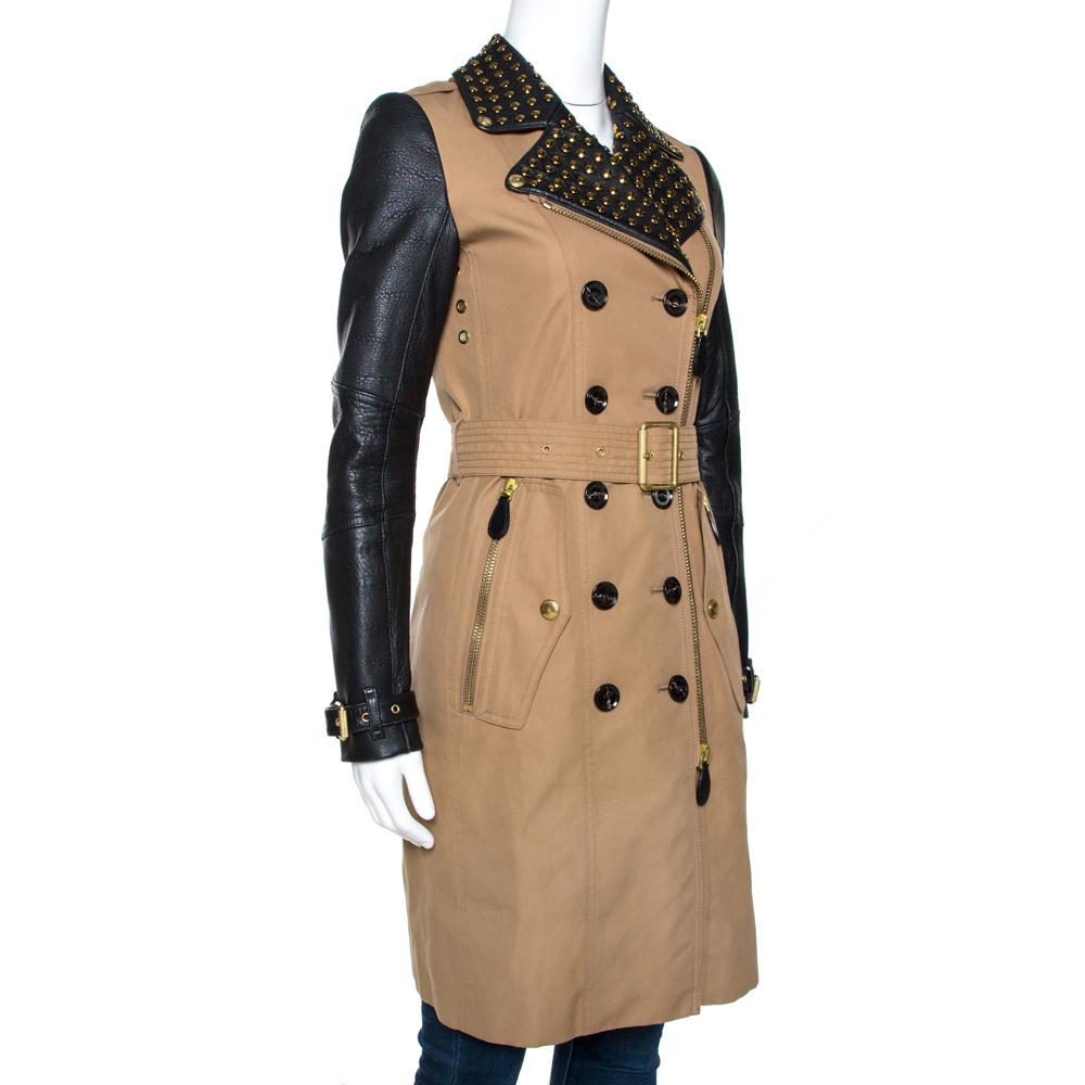 This creation from Burberry Brit is beauty tailored into a coat. It brings a charming combination of black and beige hues on a design that is classic. Made from cotton and leather, the coat features a zipped front, long leather sleeves with buckle