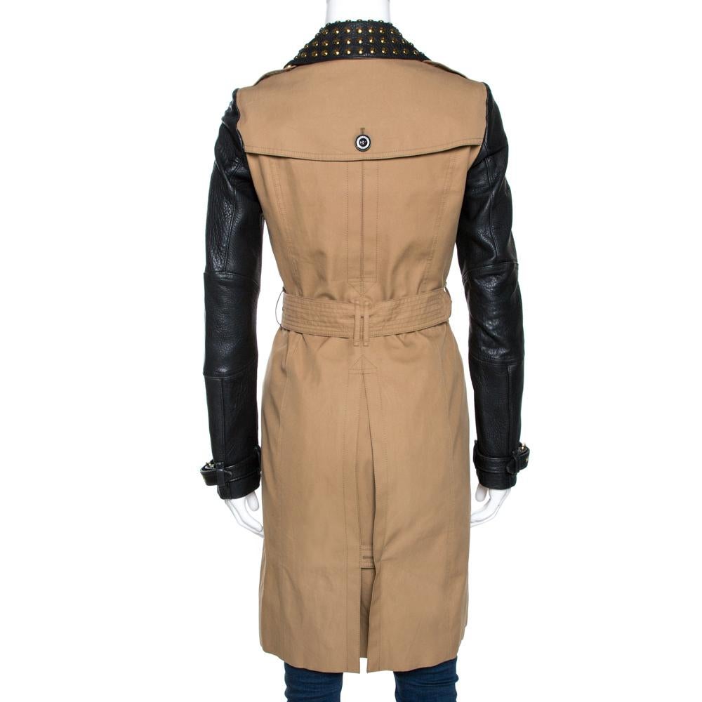 This creation from Burberry Brit is beauty tailored into a coat. It brings a charming combination of black and beige hues on a design that is classic. Made from cotton and leather, the coat features a zipped front, long leather sleeves with buckle