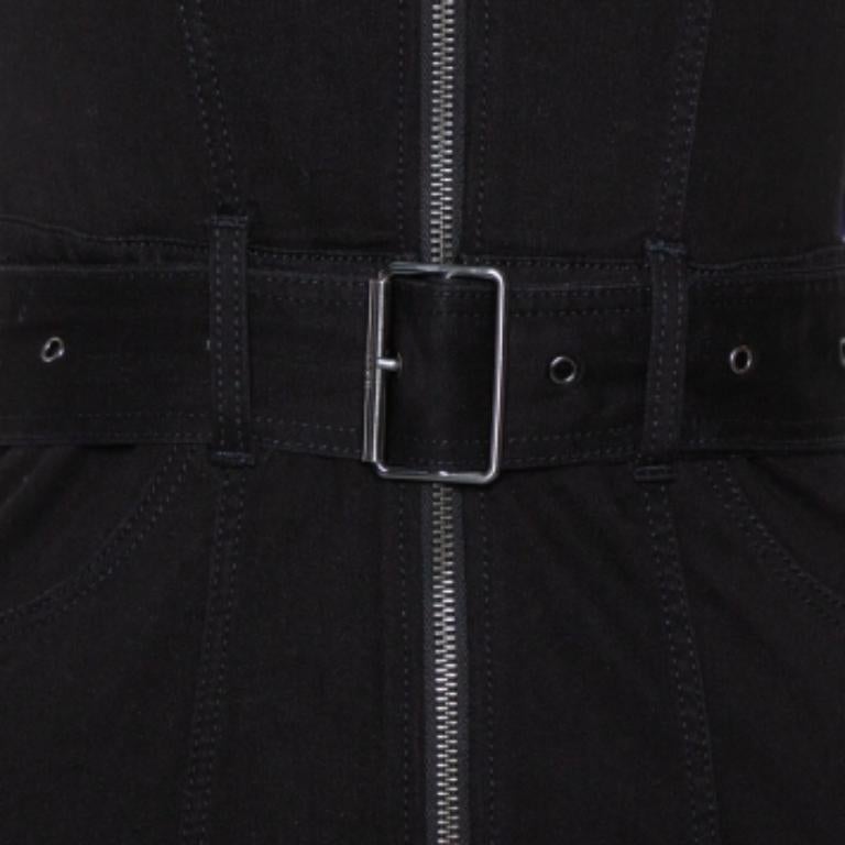 A Burberry Brit dress to exhibit your fantastic styling choices to the world! The black denim creation has been designed with a long front zip closure, a buckle belt detailing on the waist, and a collared neckline. It comes equipped with two pockets