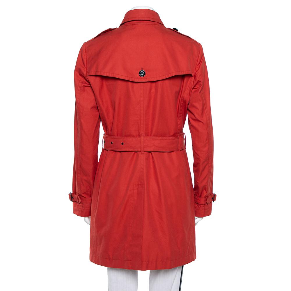 Always feel in sync with classic fashion with this Burberry Brit coat. This piece will make a fashionable add-on to any outfit. It is tailored from cotton and designed with a double-breasted front. The belt adds the perfect finishing element to this