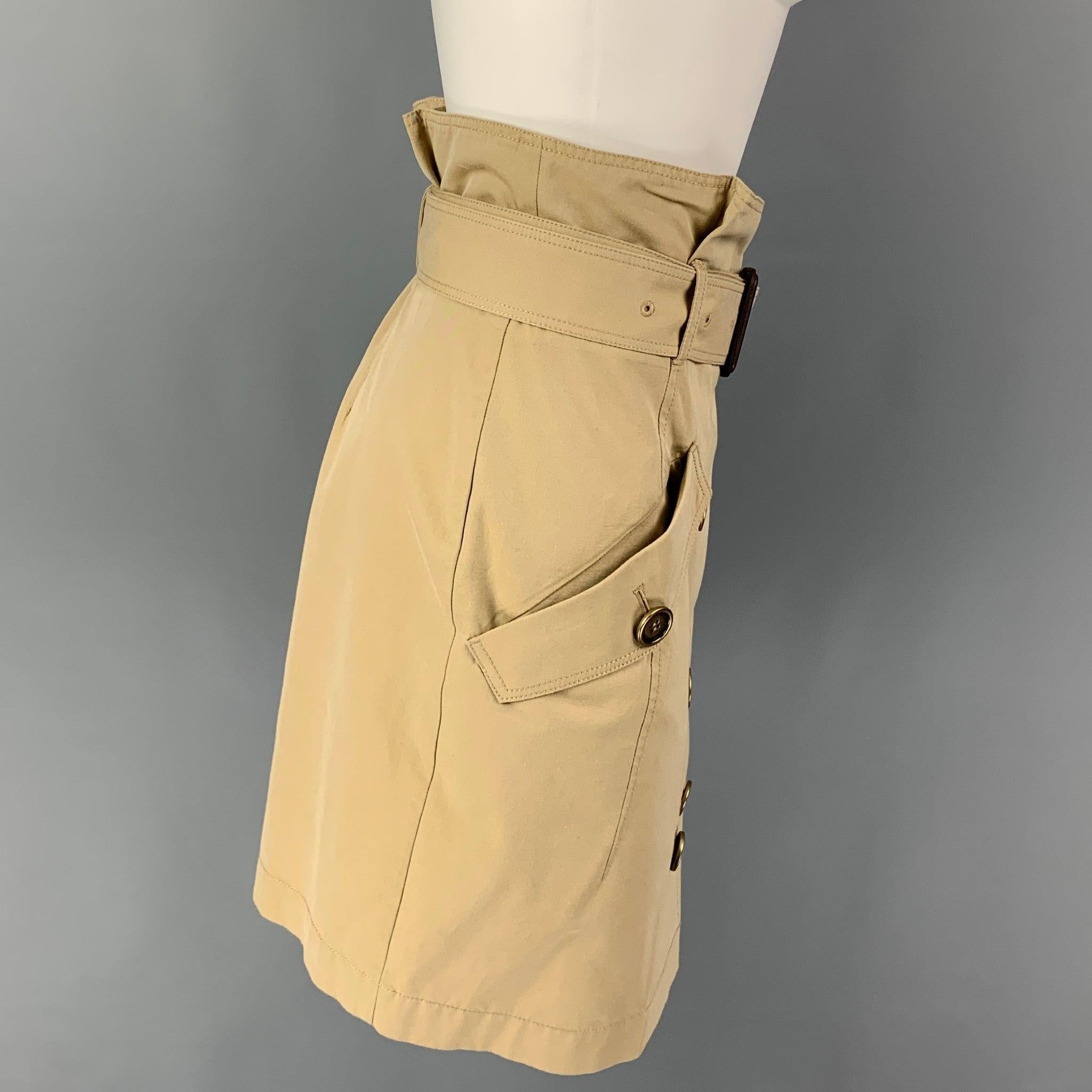 BURBERRY BRIT skirt comes in a khaki cotton featuring a belted style, flap pockets, and a double breasted closure.
Very Good
Pre-Owned Condition. 

Marked:   UK 8 / USA 6 / IT 40 / GER 36 

Measurements: 
  Waist: 30 inches  Hip: 36 inches  Length: