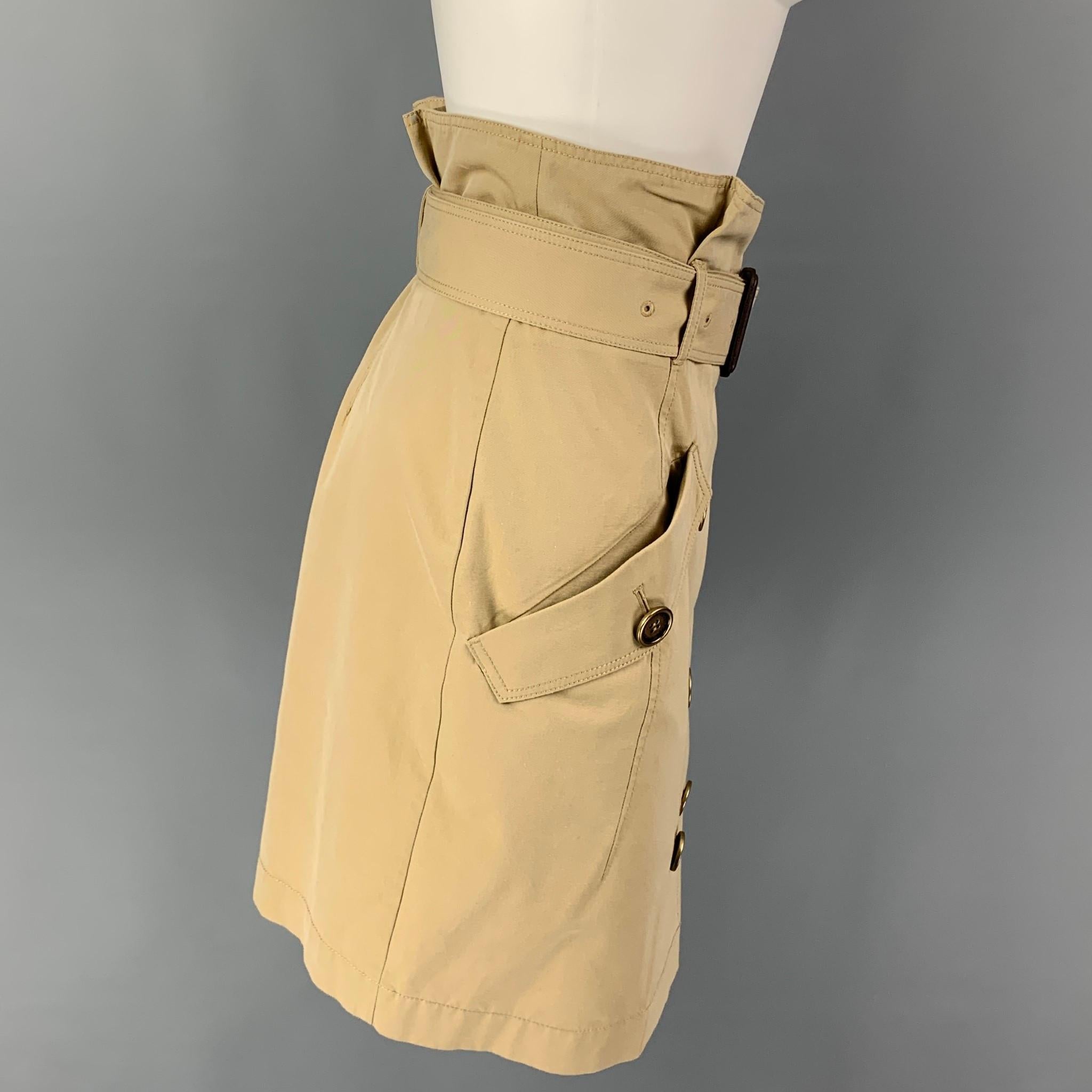 BURBERRY BRIT skirt comes in a khaki cotton featuring a belted style, flap pockets, and a double breasted closure. 

Very Good Pre-Owned Condition.
Marked: UK 8 / USA 6 / IT 40 / GER 36

Measurements:

Waist: 30 in.
Hip: 36 in.
Length: 22 in. 