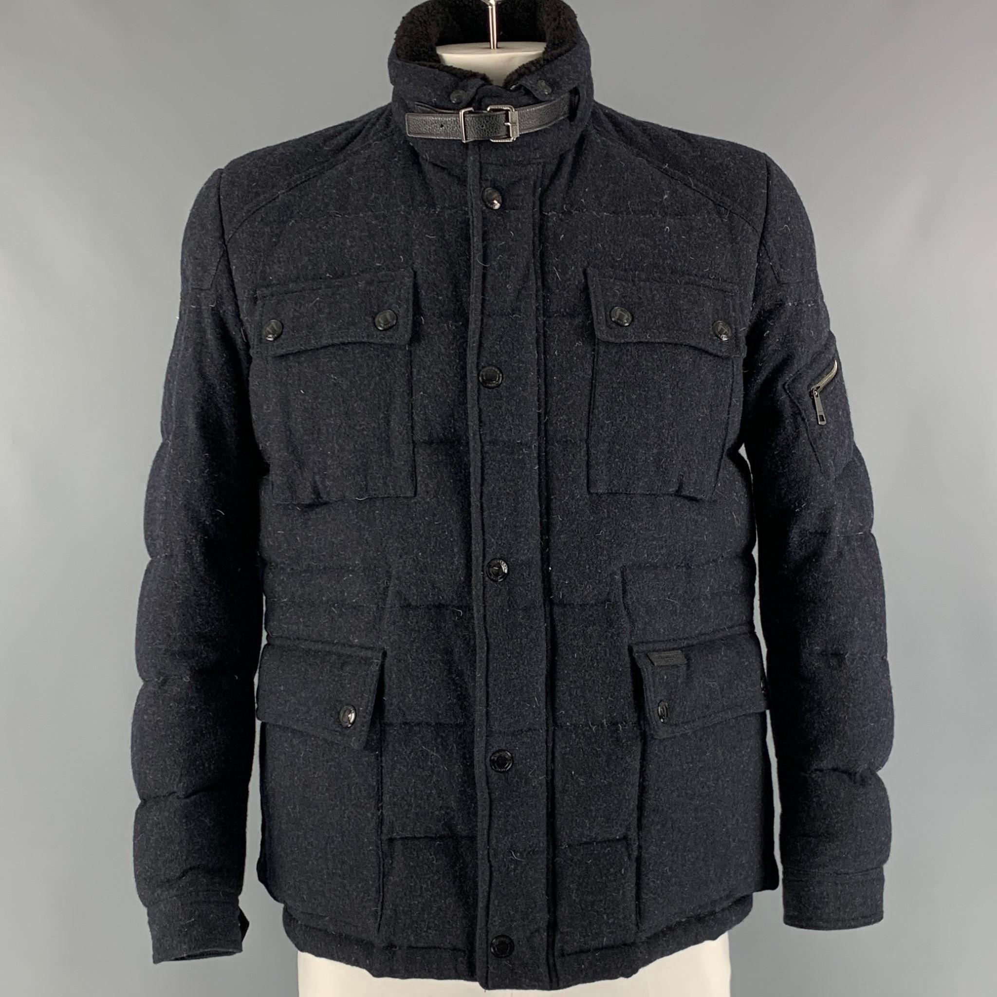 BURBERRY BRIT coat comes in a navy wool and polyamide fleece material with a plaid lining featuring a quilted style, detachable collar, flap pockets, and a  zip up closure.

Very Good Pre-Owned Condition. Minor mark at left back shoulder.
Marked: