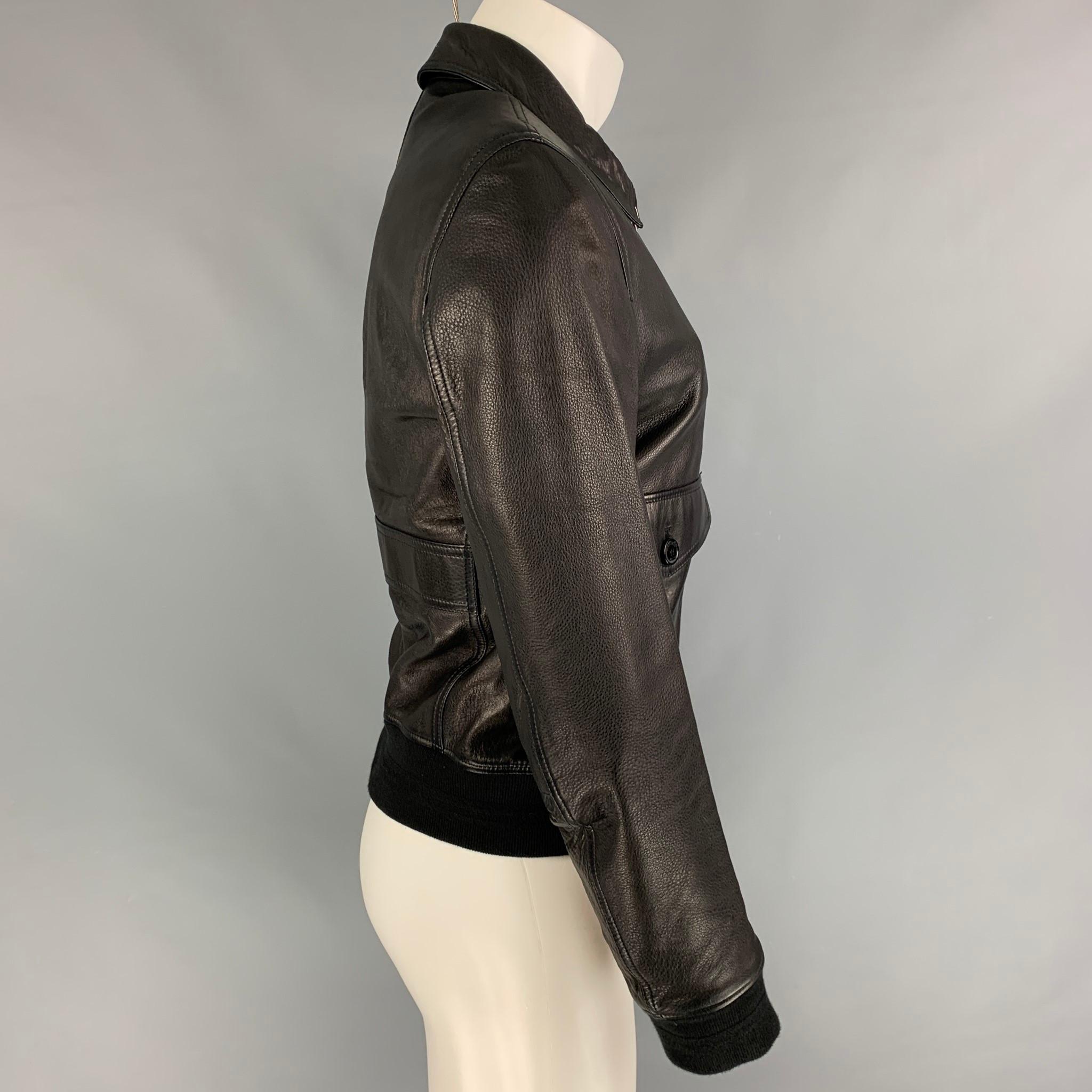 BURBERRY BRIT jacket comes in a black leather with a plaid liner featuring a ribbed hem, front pockets, spread collar, and a zip up closure. 

Very Good Pre-Owned Condition.
Marked: M

Measurements:

Shoulder: 18 in.
Chest: 40 in.
Sleeve: 26