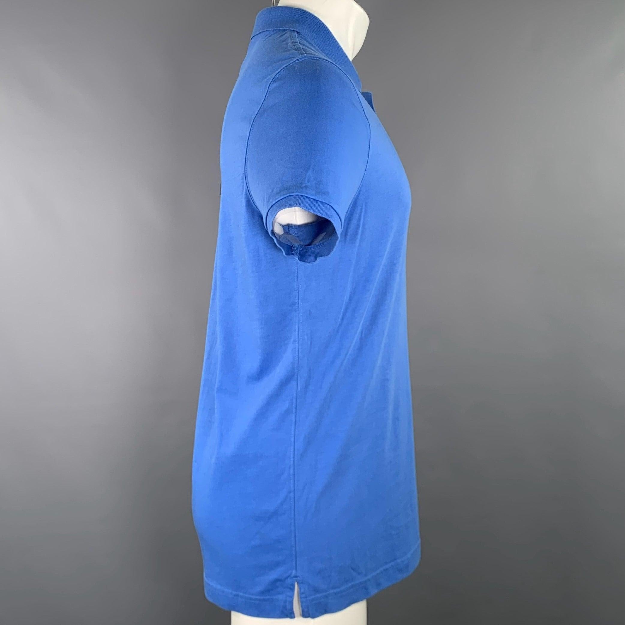 BURBERRY BRIT polo
in a blue cotton featuring short sleeves, and half placket button closure with contrasting plaid trim.Excellent Pre-Owned Condition. 

Marked:   M 

Measurements: 
 
Shoulder: 16.5 inches Chest: 41 inches Sleeve: 8 inches Length: