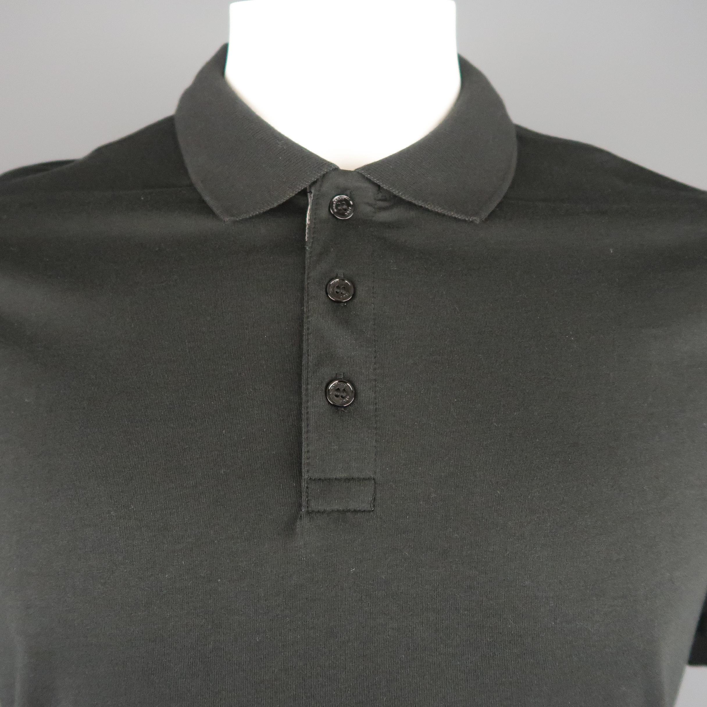 BURBERRY BRIT polo comes in black jersey with a ribbed collar and plaid lined button closure.
 
Very Good Pre-Owned Condition.
Marked: XL
 
Measurements:
 
Shoulder: 1 in.
Chest: 46 in.
Sleeve: 9 in.
Length: 31 in.