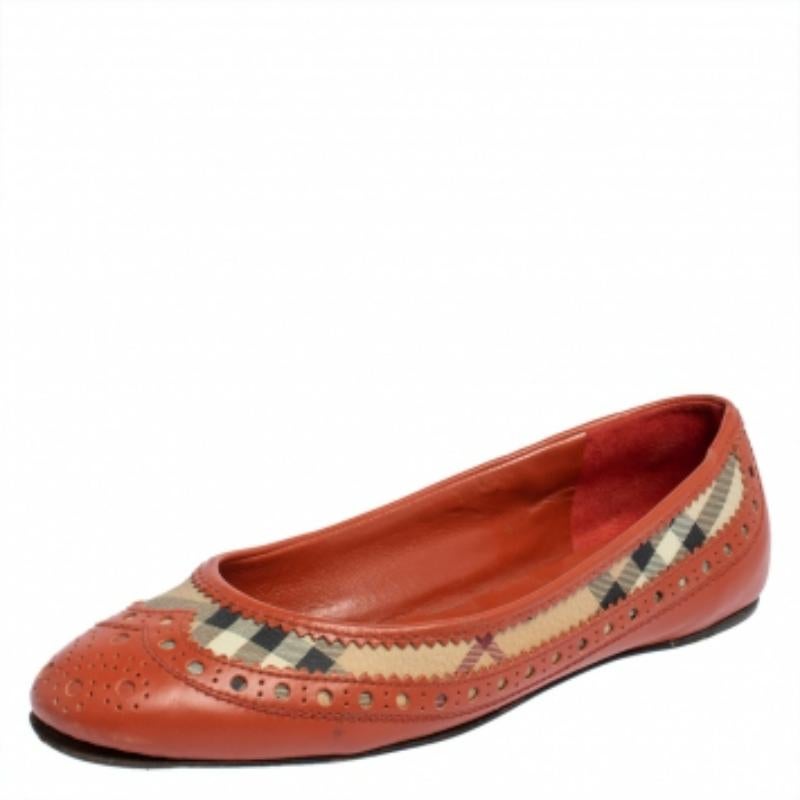 These chic ballet flats from Burberry will make you look pretty and fashionable! The orange flats are crafted from brogue leather and the signature Haymarket Check canvas and feature round toes. They come equipped with comfortable leather-lined