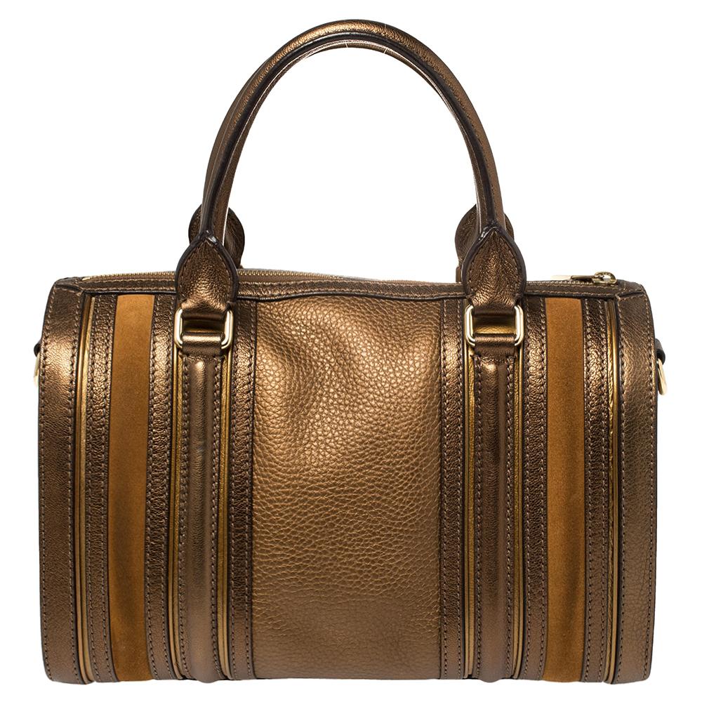 This bronze-hued Alchester Bowling bag is a Burberry must have. It is made from leather with suede & leather trim. It comes with double-rolled leather handles and a top zip closure. It is highlighted with gold-tone hardware and comes with a