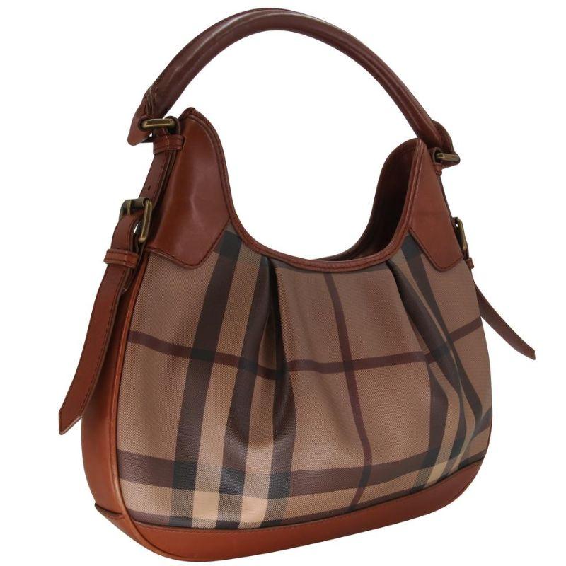 Burberry Brooklyn Coated Canvas Smoked Check Handbag Brown Leather Shoulder Bag

This adorable Burberry Smoked Canvas Brooklyn Hobo Bag is perfect for carrying your girly essentials in style. It features durable Smoked Check coated canvas with brown