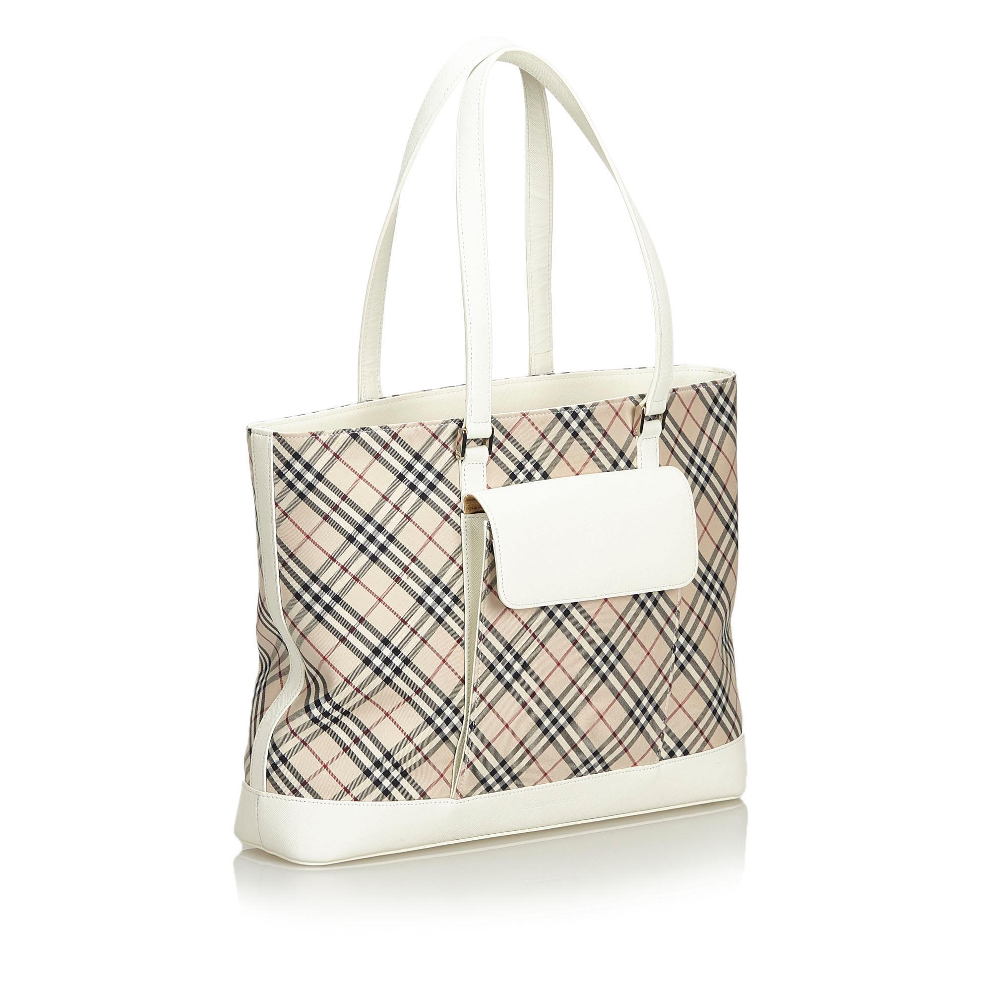 This tote bag features a plaid cotton body with leather trim, a front exterior flap pocket, flat leather straps, a top zip closure, and interior zip and slip pockets. It carries as AB condition rating.

Inclusions: 
This item does not come with