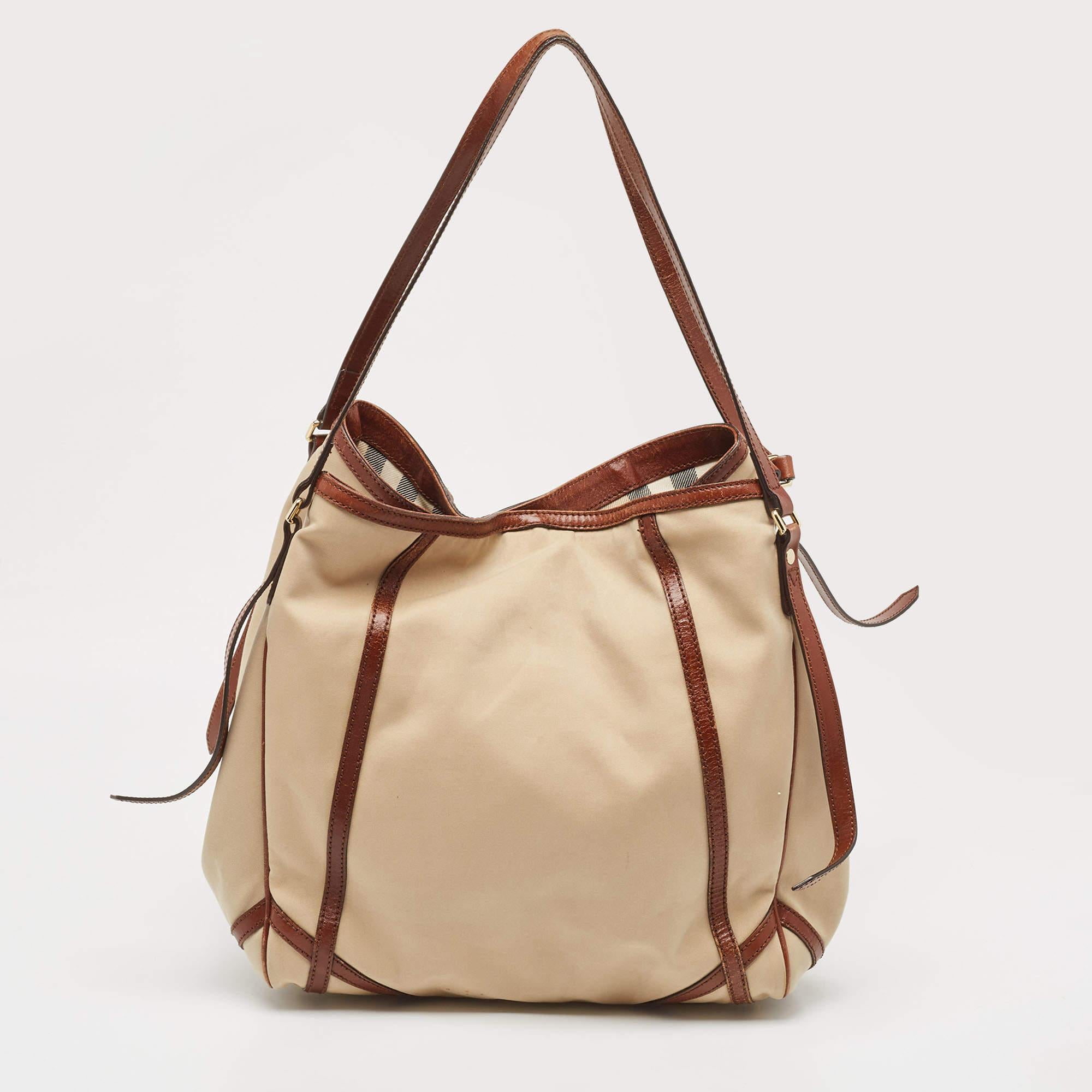 Elevate your style with this Burberry bag. Merging form and function, this exquisite accessory epitomizes sophistication, ensuring you stand out with elegance and practicality by your side.

Includes: Original Dustbag

