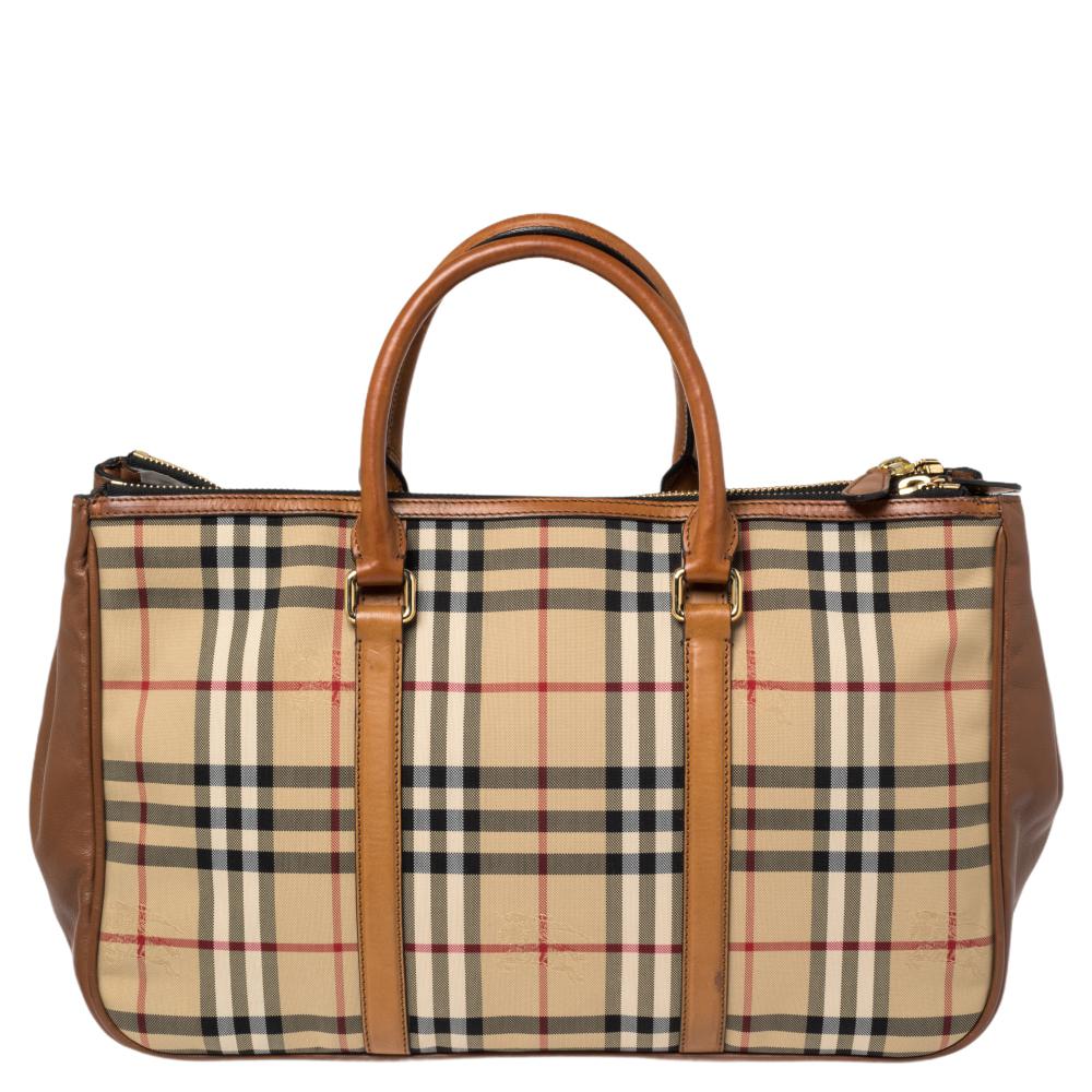 Carry everything you need in style thanks to this Burberry tote. Crafted from Haymarket check canvas and leather, it features dual leather handles and a canvas-lined interior with one zip pocket.

Includes: Original Dustbag, Info Booklet