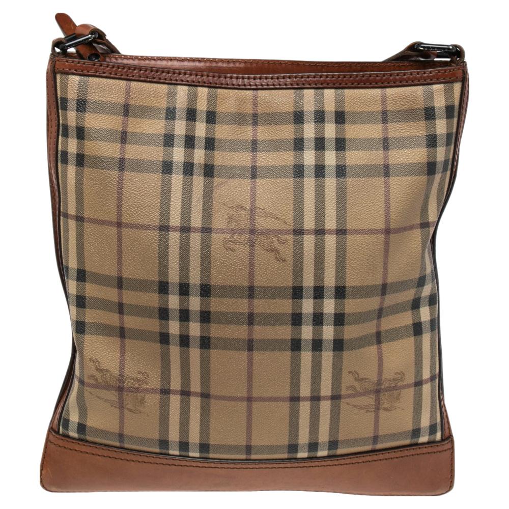 This lovely messenger bag by Burberry is stylish and functional. It has been crafted from brown & beige Haymarket check canvas & leather. It has a long strap, black-tone hardware and a spacious canvas-lined interior.

Includes: Original Dustbag
