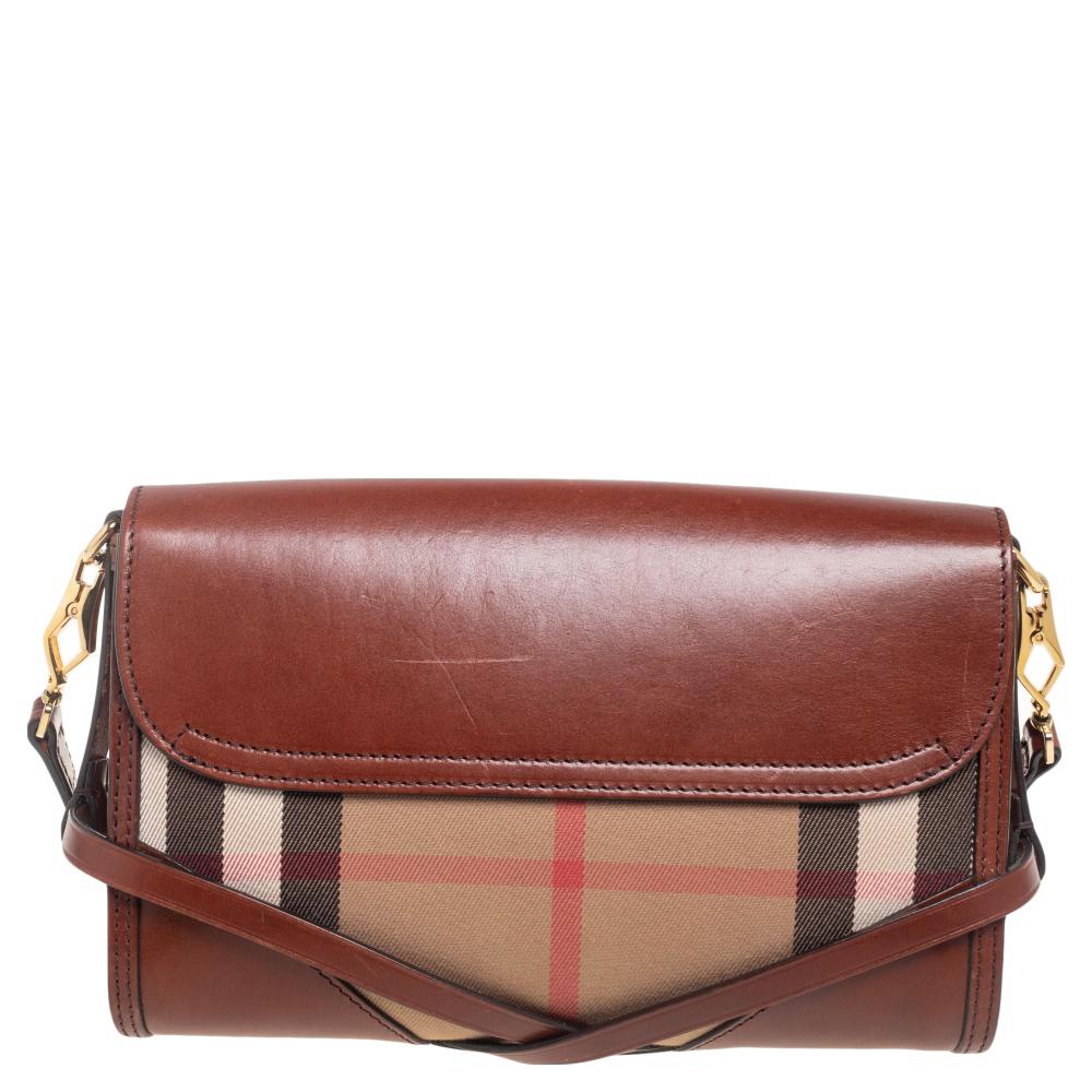 Complement your OOTD with the right accessory by choosing this bag from Burberry. It has been crafted from leather as well as Nova check canvas, and it comes with a well-sized canvas interior. It is added with a long shoulder strap, gold-tone