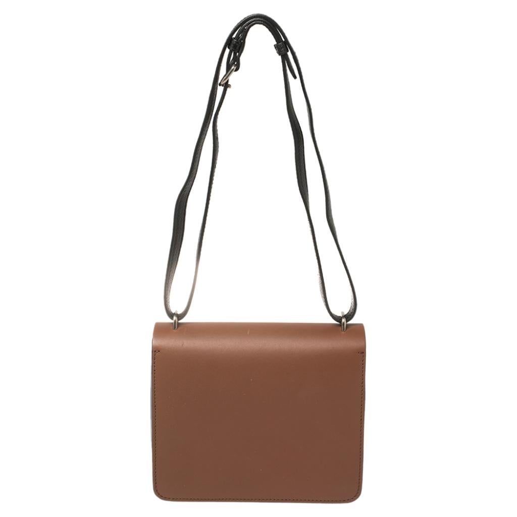 Masterfully crafted from leather, this creation in black-brown can easily hold all your little essentials. This chic shoulder bag by Burberry features an adjustable shoulder strap, a D-ring detail, and a leather interior secured by a