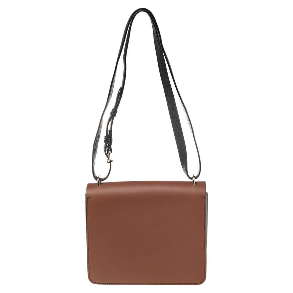 Masterfully crafted from leather, this creation in black-brown can easily hold all your little essentials. This chic shoulder bag by Burberry features an adjustable shoulder strap, a D-ring detail, and a leather interior secured by a