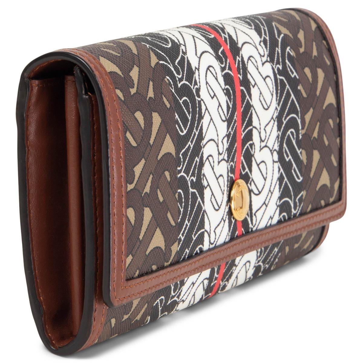 100% authentic Burberry Monogram Stripe Continental Wallet in black, white, red and brown Monogram canvas and brown leather. Opens with a fold-over top with press-stud fastening and has six credit card slots on each side, four bill slips and a