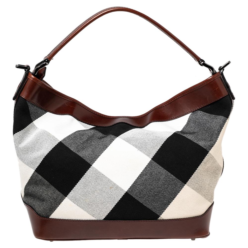 This shoulder bag from the House of Burberry is both elegant and fashionable. Crafted from brown Check canvas and leather, this bag features black-tone hardware and a canvas-lined interior. It has a single handle. This exquisite bag will complete