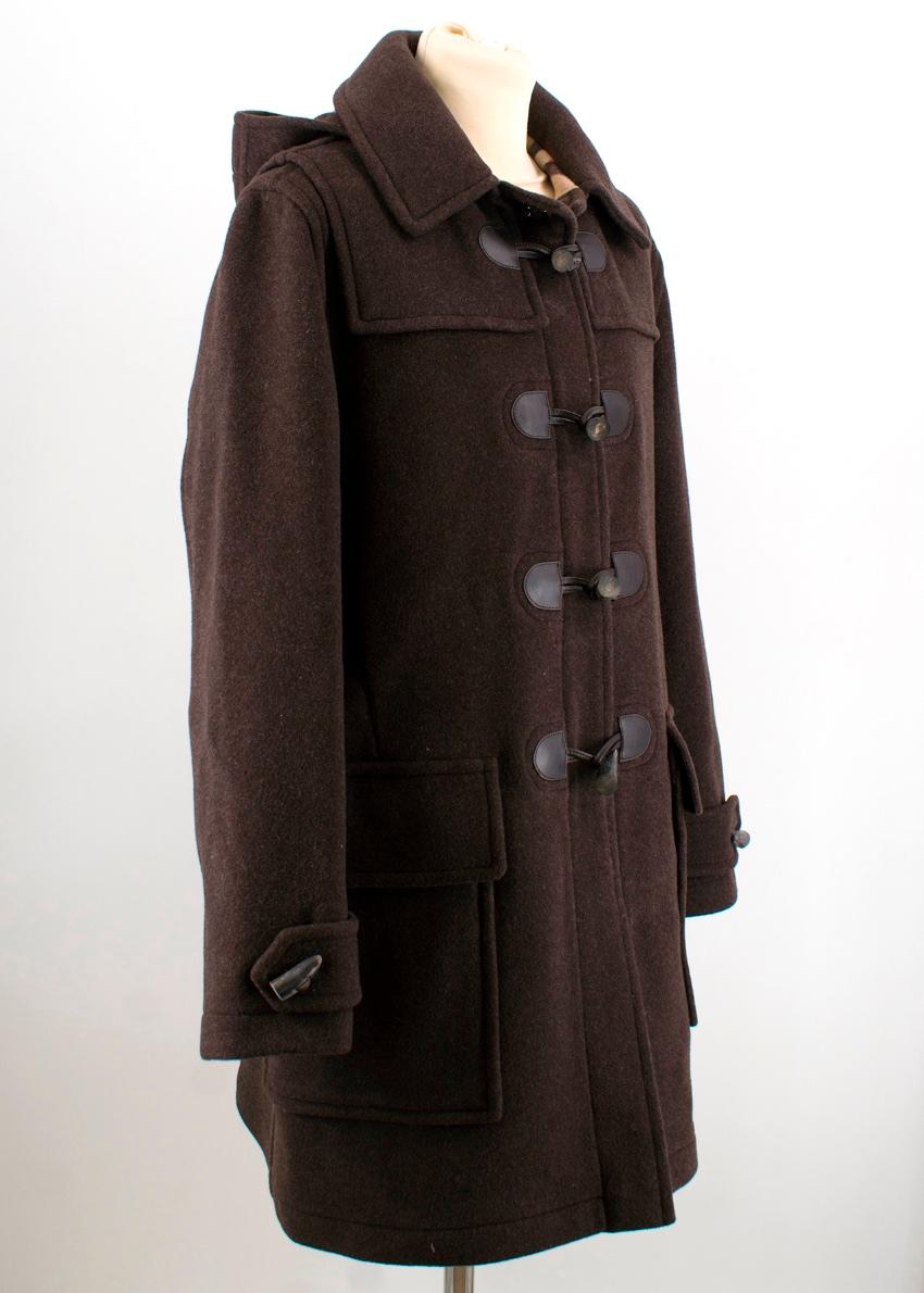 Burberry Brown Duffle Coat
- Oversized, long line silhouette
- Hooded 
- Signature check inside lining 
- Button and toggle closures 
- Leather trimmings 
- Patch pockets on the front 
- Signature button-tab cuffs 
- Long sleeves 

Please note,