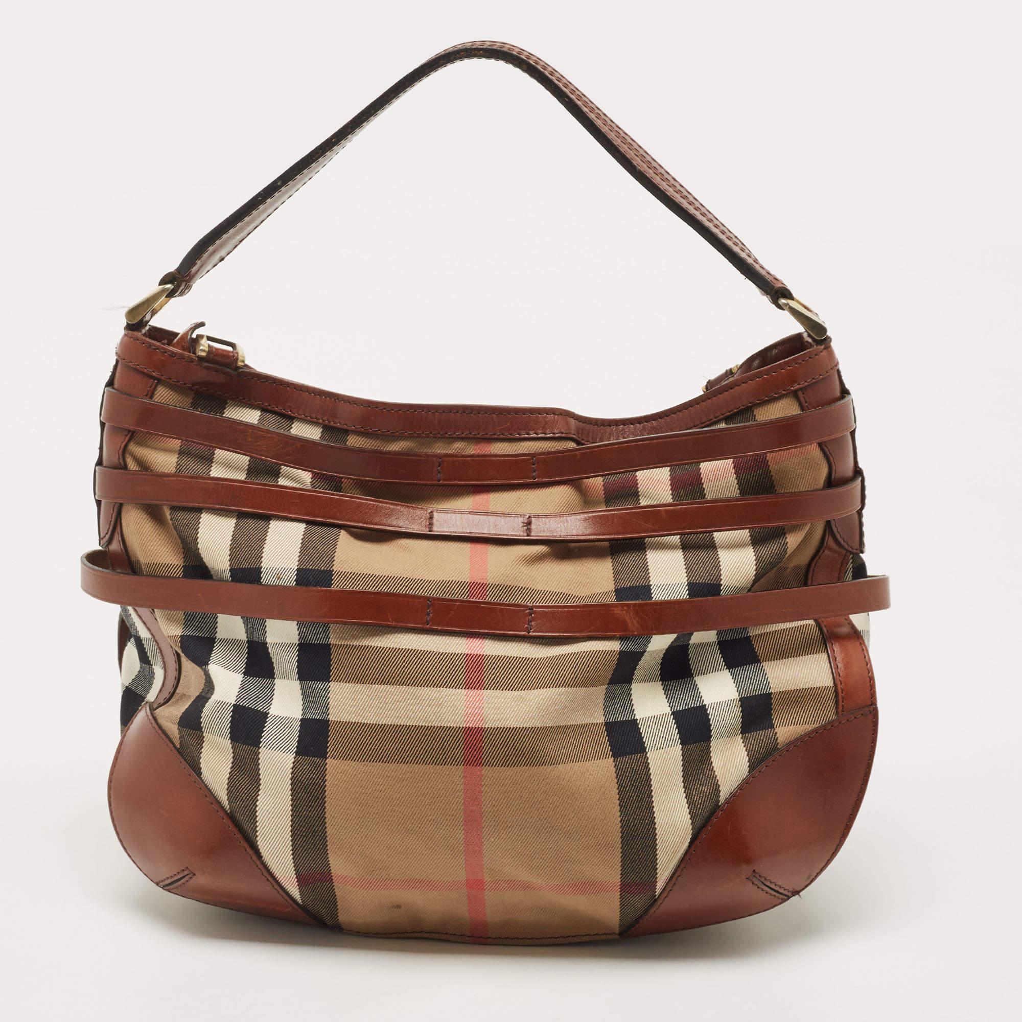 Marked by flawless craftsmanship and enduring appeal, this Burberry hobo is bound to be a versatile and durable accessory. It has a spacious size.

Includes: Original Dustbag

