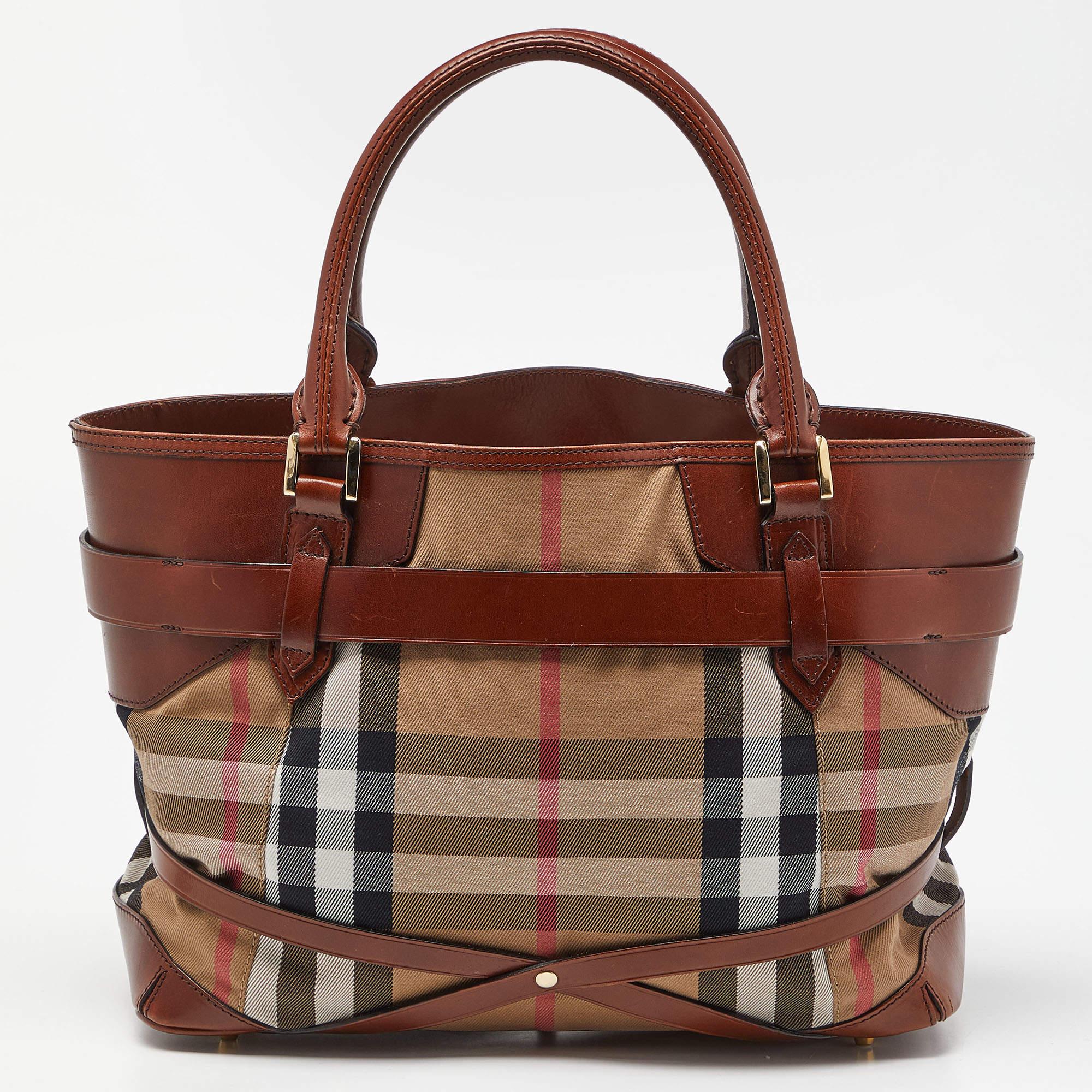 Walk out the door with the Burberry tote on your arm. Fashioned in House Check fabric & leather, the tote has two short handles and a spacious interior.

