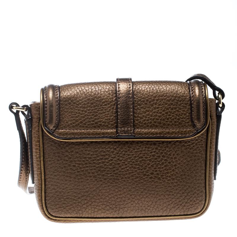 This Burberry Mini Berkeley crossbody bag is a cute addition to your bag collection. Made from brown metallic leather and features a suede panel to the front. It comes with gold-tone hardware on the adjustable shoulder strap and buckled flap. Lined