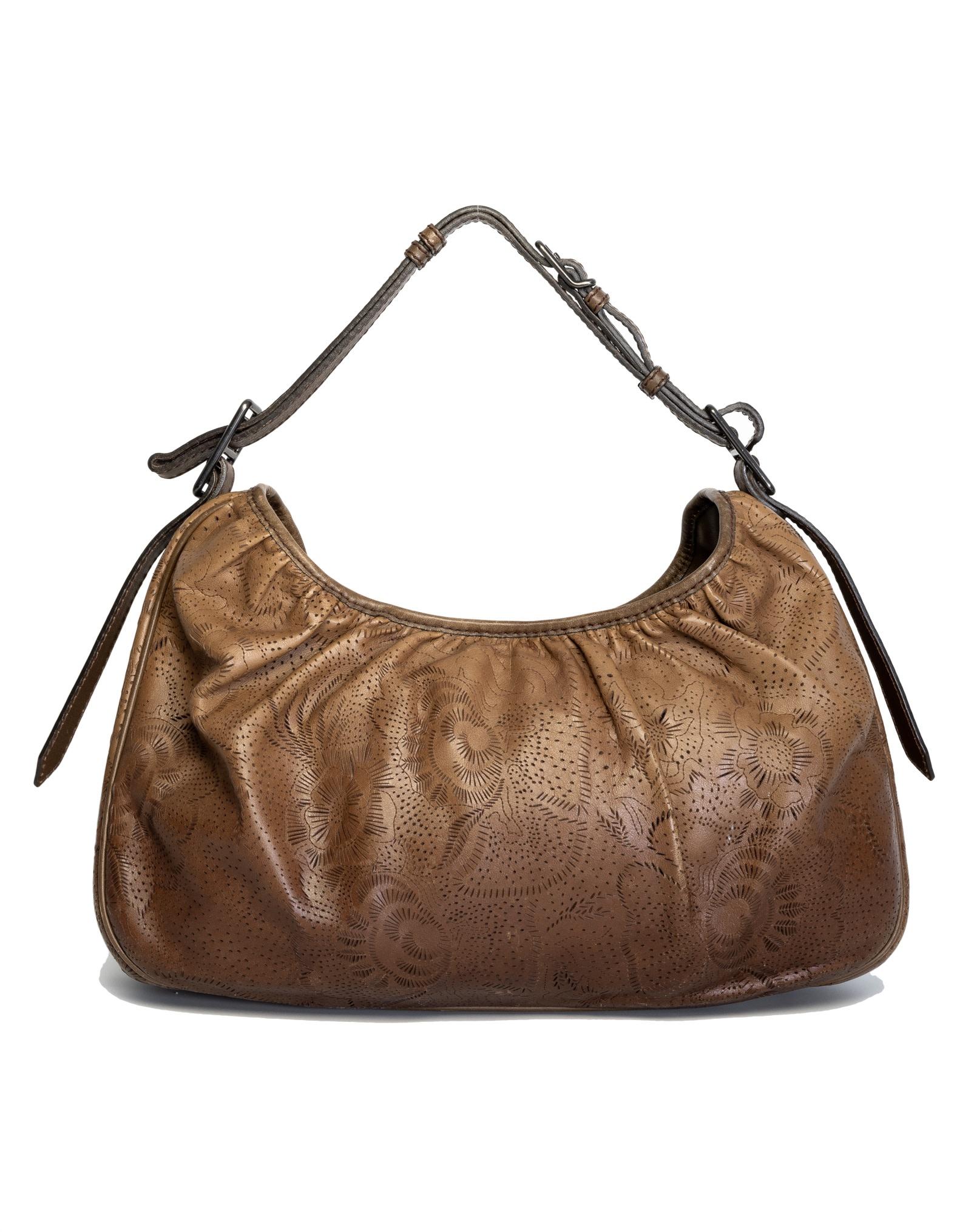 Burberry Hobo bag made of leather with laser-cut floral detailing, adjustable shoulder strap, top zipper closure and an open interior with nylon lining and zip and slip pockets. 

COLOR:  Brown
MATERIAL: Laser cut leather 
ITEM CODE: