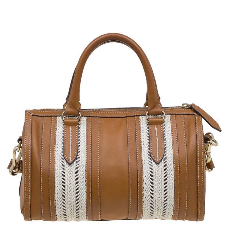 The retro inspired bowling bag by Burberry exhibits the outstanding Italian craftsmanship. Crafted from exemplary brown coloured textured leather, which is used for the brand’s trench coat at the Burberry mill in England, this bowling bag with