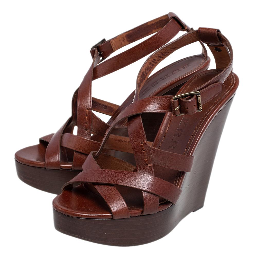 Wear these leather sandals when you go out and feel your stylish best. Glam up your outfit with these leather sole sandals. This pair from Burberry is one of a kind in trendy women's footwear. You need to add these versatile brown strappy clog wedge